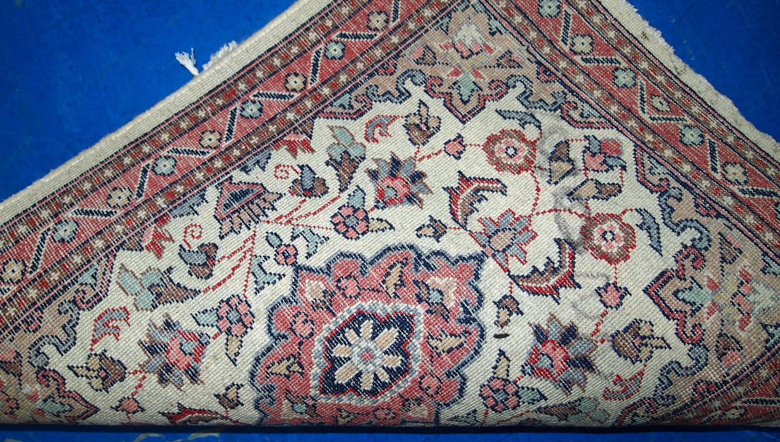 Vintage handmade Indian rug from the end of 20th century. The rug is in original good condition in a beige shade and floral design.

-condition: original good,

-circa: 1970s,

-size: 1.6' x 2.1' (49cm x 66cm),

-material: wool,

-country