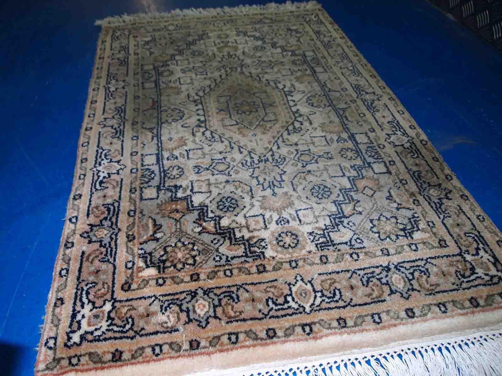 Vintage handmade Indo-Tabriz rug in original good condition. The rug is from the end of 20th century, made in wool.

-condition: original good, 

-circa: 1970s,

-size: 1.9' x 2.9' (58 cm x 89 cm),

-material: wool,

-country of origin: