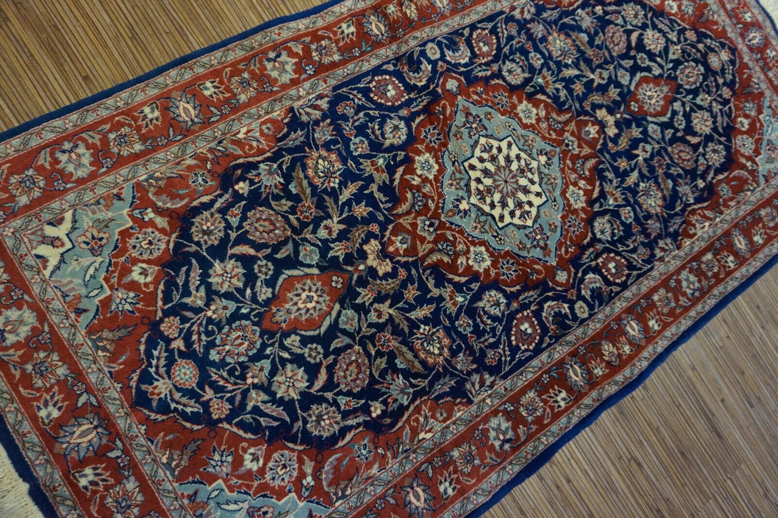 Handmade vintage Isfahan rug in traditional medallion design. The rug is from the end of 20th century in original good condition. It is made in wool.

-condition: original good,

-circa: 1970s,

-size: 2.3' x 4.5' (72cm x 140cm),

-material: