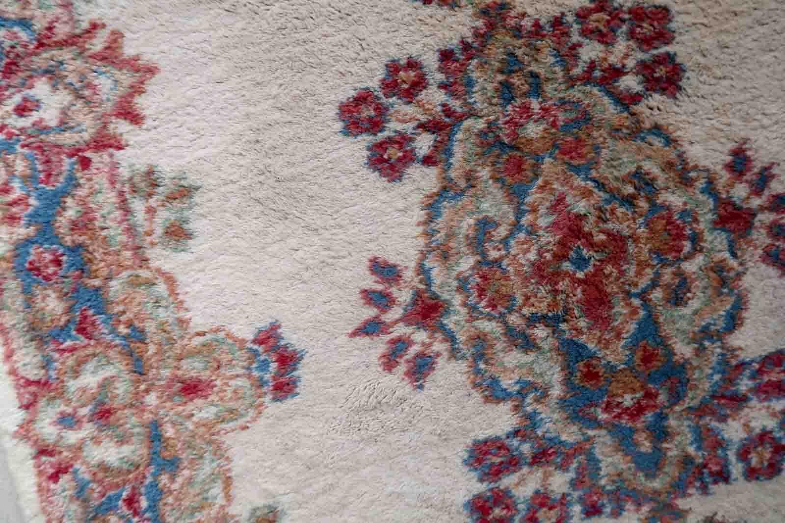 Handmade vintage Kerman rug in floral design and pastel shades. The rug is from the end of 20th century in original good condition.

-condition: original good,

-circa: 1960s,

-Size: 3' x 4.8' (92cm x 147cm),

-Material: wool,

-Country