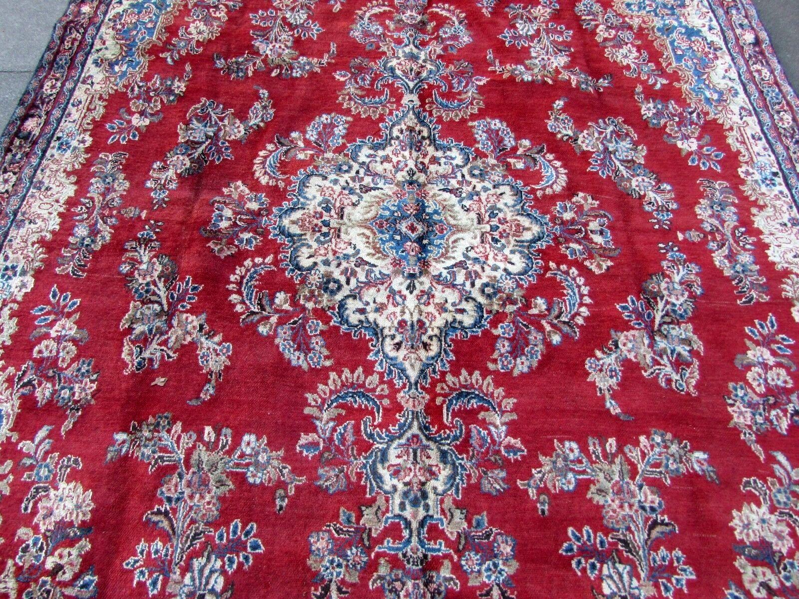 Handmade vintage Kerman rug in red and blue wool. The rug is from the end of the 20th century, it is in original good condition.

- Condition: original good,

- circa 1970s,

- Size: 7.5' x 14.3' (223cm x 428cm),

- Material: wool,

-