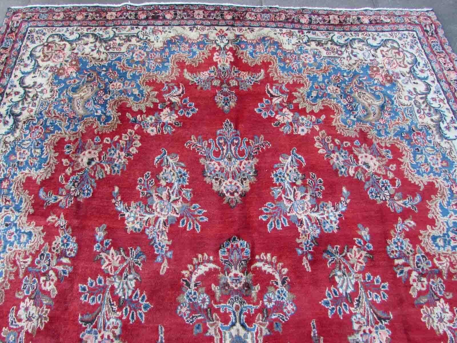 Handmade vintage Kerman rug in bright red and sky blue color. The rug is from the end of 20th century in original condition, it has some low pile.

-condition: original, some low pile, 

-circa: 1970s,

-size: 7.3' x 14' (223cm x