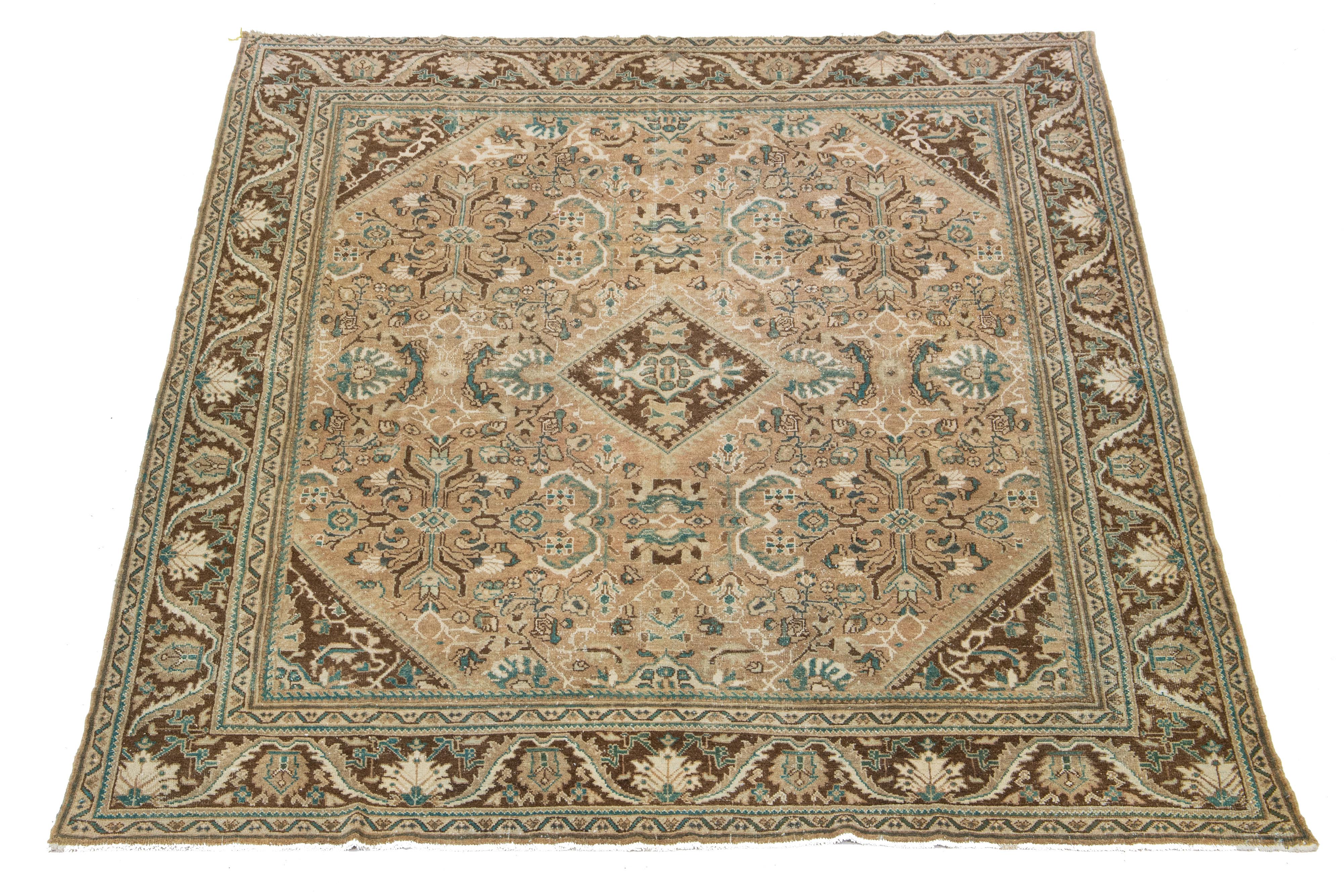Beautiful Vintage Mahal hand-knotted wool rug with a brown color field. This Persian rug has classic blue and beige hues throughout the floral motif.

This rug measures 9'10