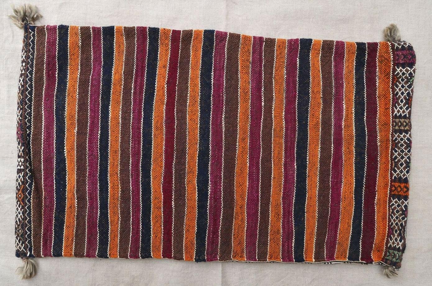 Handmade vintage Moroccan Berber cushion made out of vintage Kilim. The flat-weave is from the mid-20th century, it is in original good condition.

- Condition: Original good,

- circa 1950s,

- Size: 1.2' x 2.1' (37cm x 66cm),

- Material: