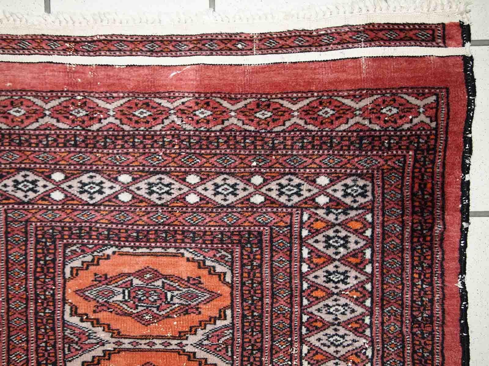 Handmade vintage Uzbek Bukhara distressed rug in traditional design. The rug is from the end of 20th century, it has some low pile.

-condition: distressed,

-circa: 1960s,

-size: 2.4' x 4.3' (75cm x 132cm),
?
-material: wool,

-country