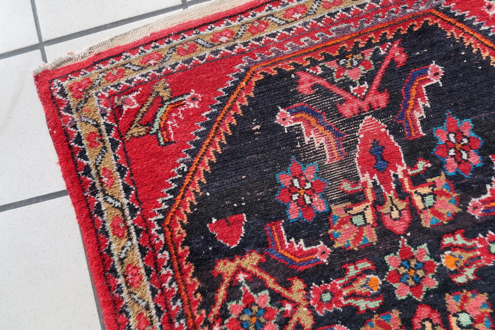 Handmade Vintage Persian Hamadan Rug:

Design and Aesthetics:
Originating from the 1960s, this rug carries a rich history and timeless appeal.
Measuring 74cm x 129cm (approximately 2.4’ x 4.2’), it’s a compact yet impactful piece.
Colors: The