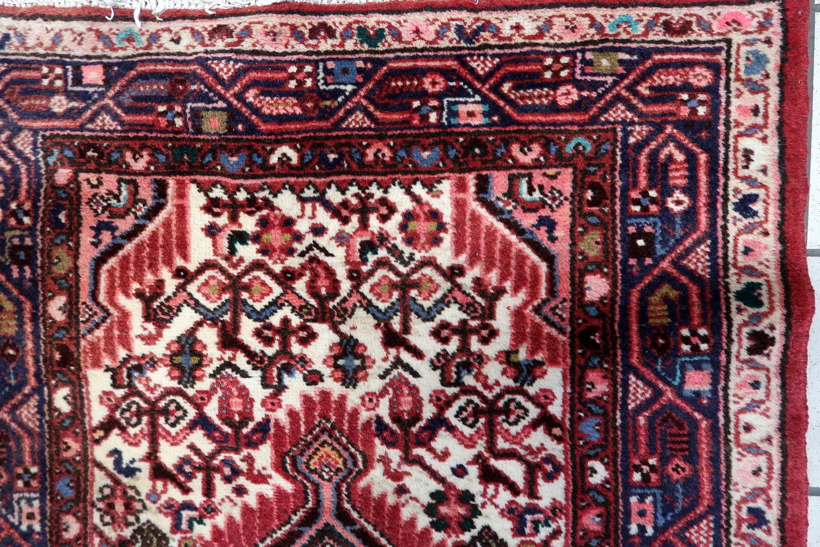 Discover the timeless allure of our Handmade Vintage Persian Hamadan Rug, a captivating piece from the 1970s. Measuring at 2.5' x 4', this rug boasts beautiful colors and features a large medallion that adds a touch of classic charm to any