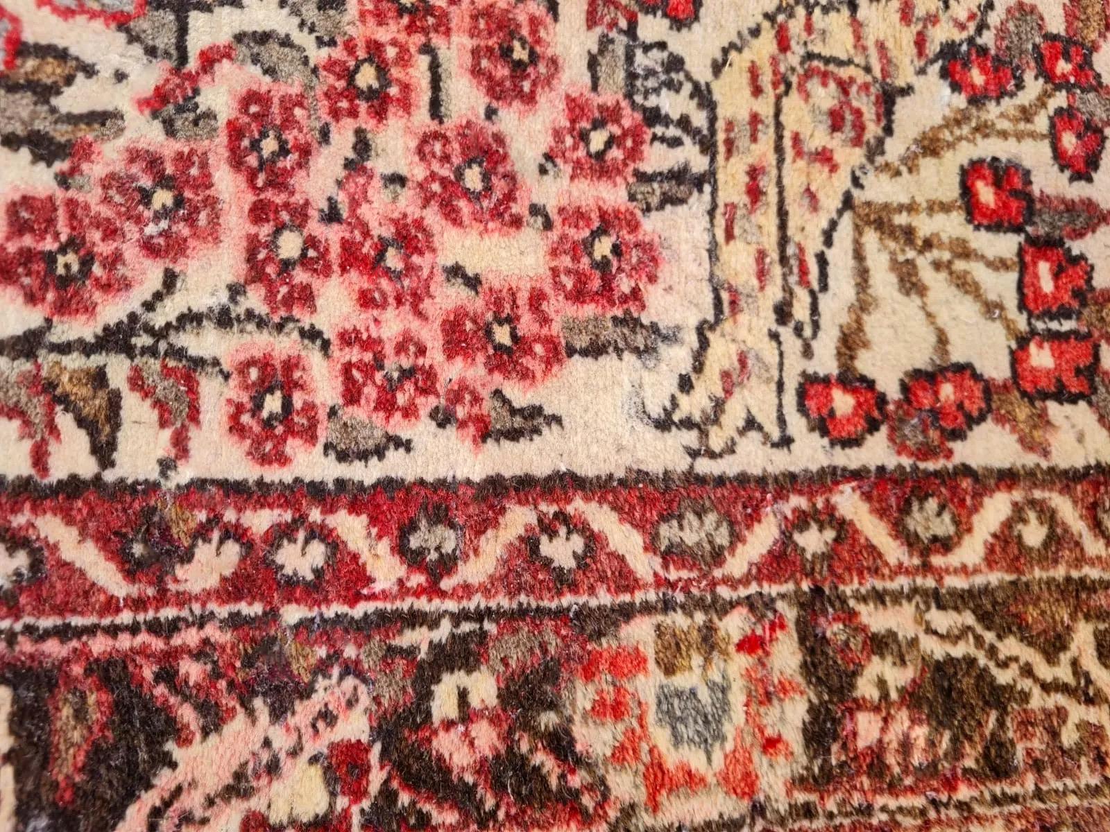 Eine poetische Antiquität aus persischen Dörfern
Dieser handgefertigte alte persische Hamadan-Teppich aus den 1950er Jahren ist ein wahrhaft fesselndes Stück, das auf wunderbare Weise künstlerische Symbolik mit dem robusten Charme der dörflichen