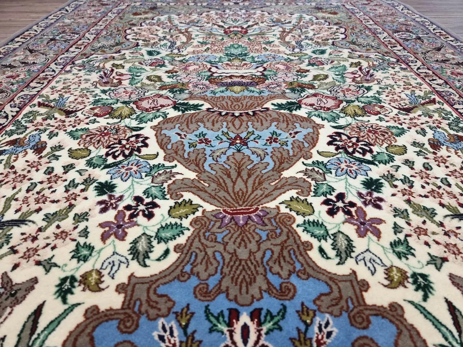 Elevate your interior with this exquisite Persian Isfahan rug, crafted with unparalleled finesse. Hand-knotted in the 1950s, this luxurious piece boasts intricate floral designs woven from premium kork wool on a silk foundation. Originally used as a
