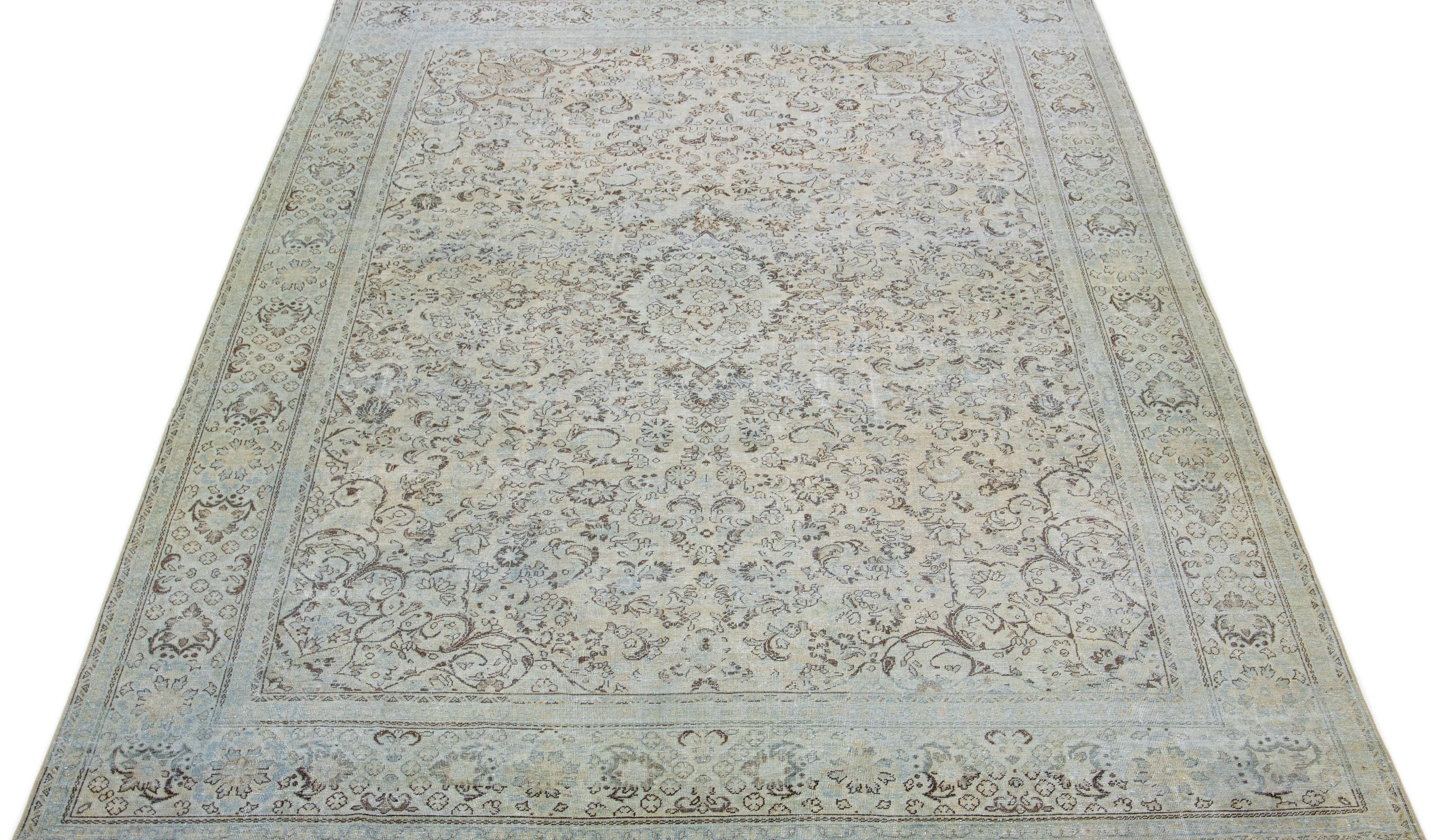 This hand-knotted mahal wool rug features a beige color field accented by blue and brown hues arranged in a classic floral medallion pattern.

This rug measures: 10' x 15'3