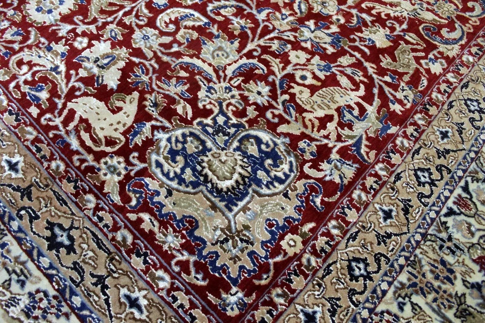 An exquisite and rare vintage Nain rug, hand-knotted with the finest wool and silk highlights, featuring an exceptional design with animals woven throughout the pattern. This unique motif, combined with elegant Persian floral detailing, makes it a