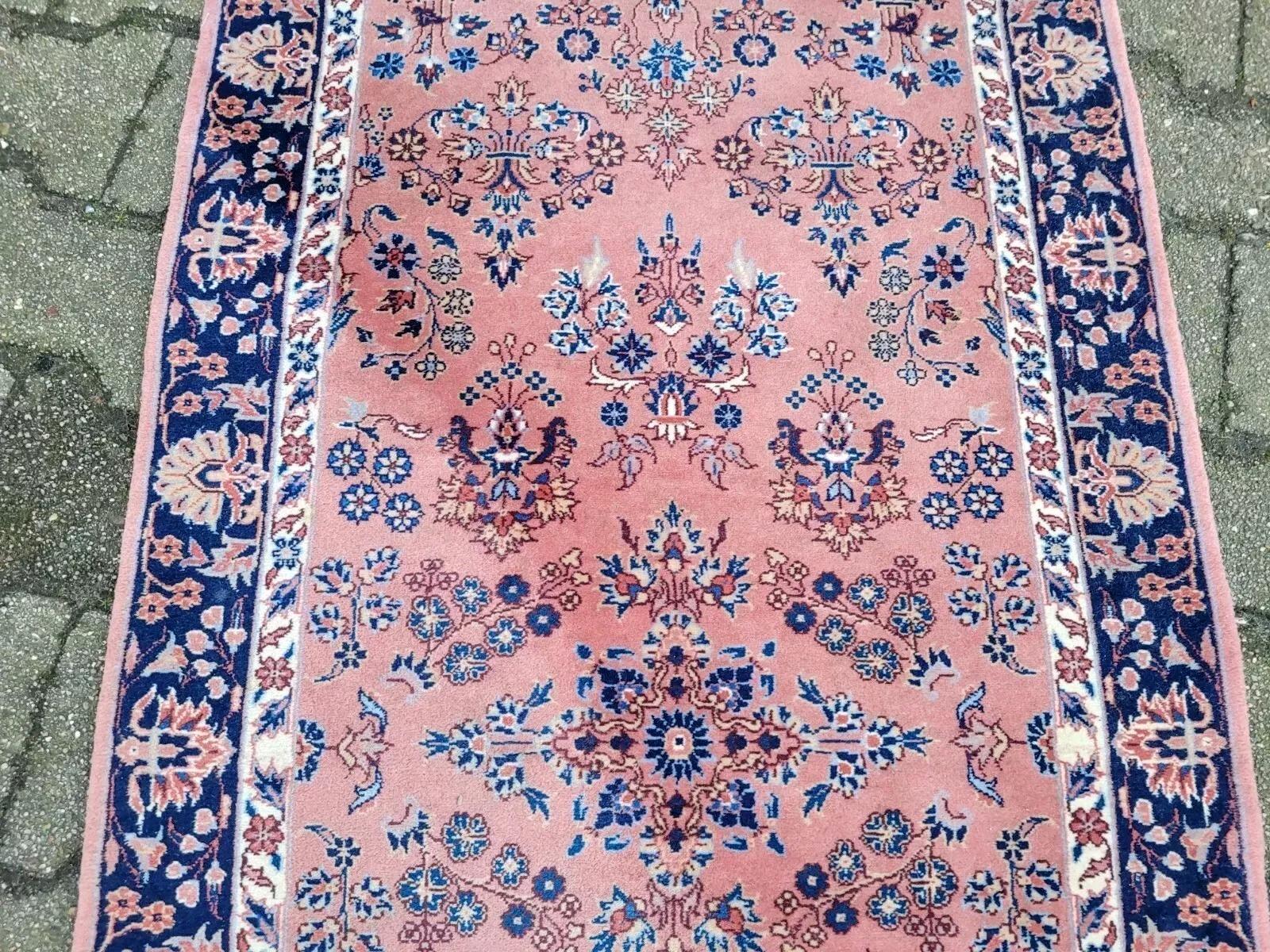A Touch of Timeless Elegance from Persia
This exquisite handmade vintage Persian Sparta rug, dating from the 1970s, offers a charming blend of traditional Persian artistry and soft, inviting hues. Crafted from 100% natural wool, this piece is in