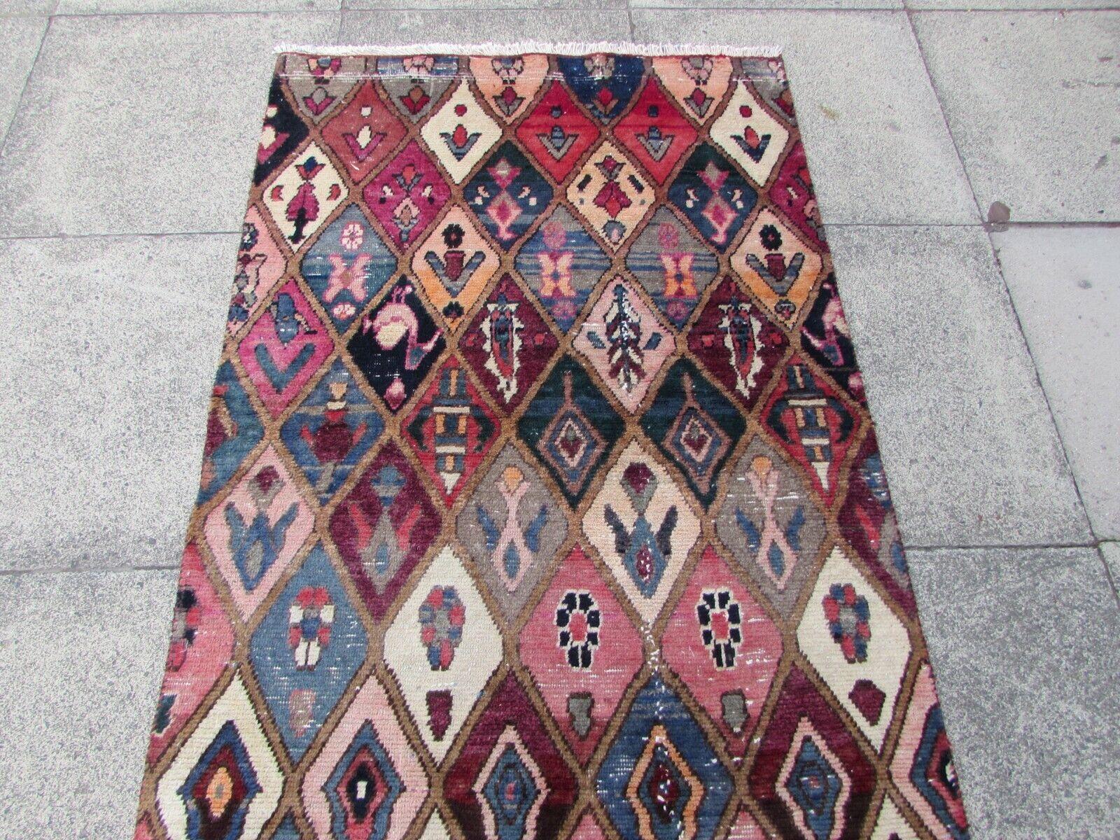 Introduce the charm of a Persian garden into your home with this Handmade Vintage Persian Style Bakhtiari Runner Rug. Crafted in the 1970s, this runner showcases a vivid garden design that's sure to brighten your living space.

Key Features:

Size: