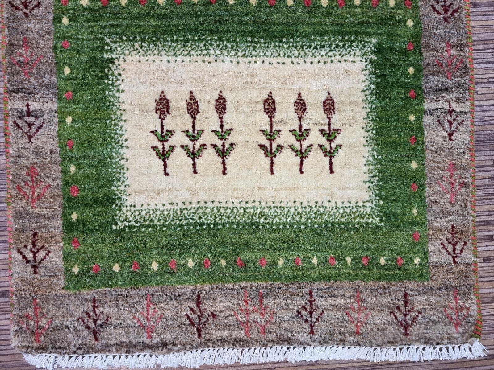Step into a world of comfort and style with this exquisite Handmade Vintage Persian Style Gabbeh Rug. Crafted meticulously from high-quality wool, this rug is in good condition, promising durability and a soft touch underfoot.

Colors &