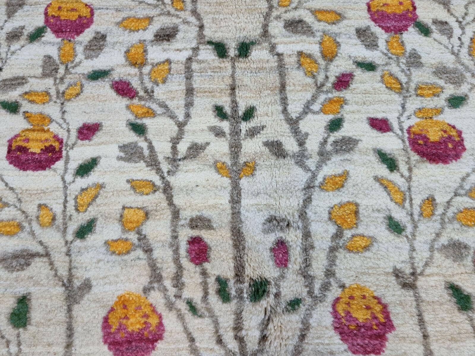 Add a touch of nature and warmth to your home with our Handmade Vintage Persian Style Gabbeh Rug, a masterpiece of craftsmanship and artistry. This wool rug measures 4.5’ x 5.9’ (140cm x 182cm) and was made in the 1980s, but it is still in good