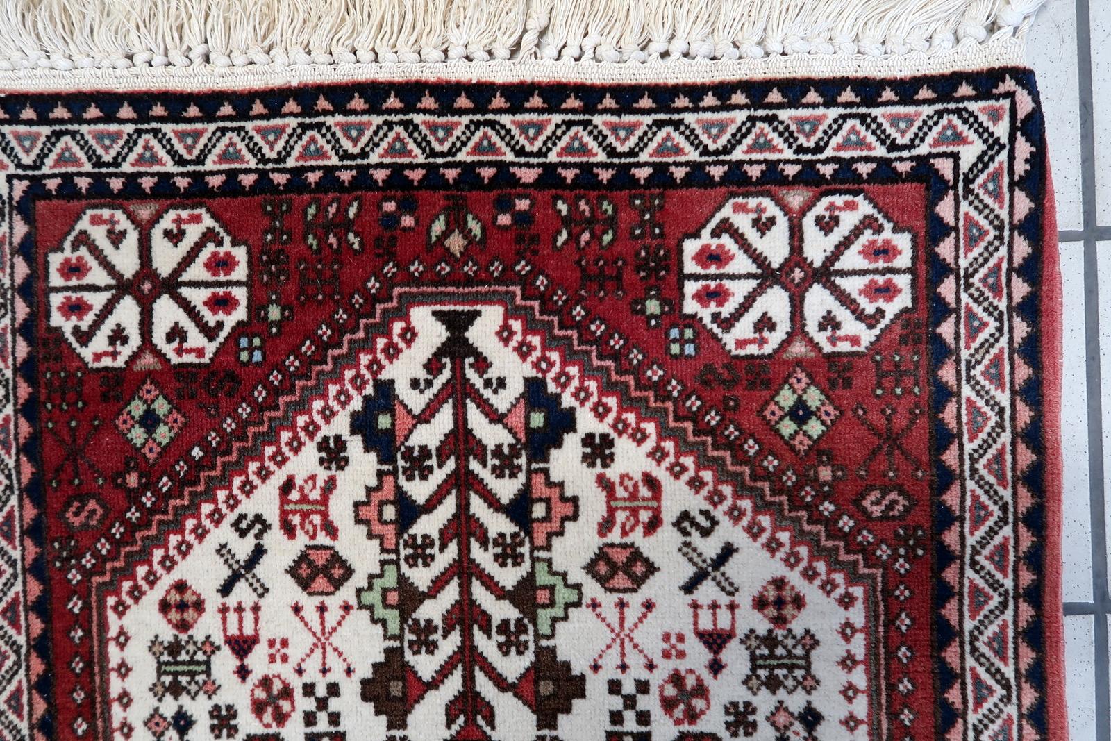 Handmade Vintage Persian Style Gashkai Rug:

Design and Colors:
This rectangular rug features intricate woven designs that echo the rich heritage of Persian craftsmanship.
The dominant colors include:
Deep Reds: These warm tones evoke a sense of