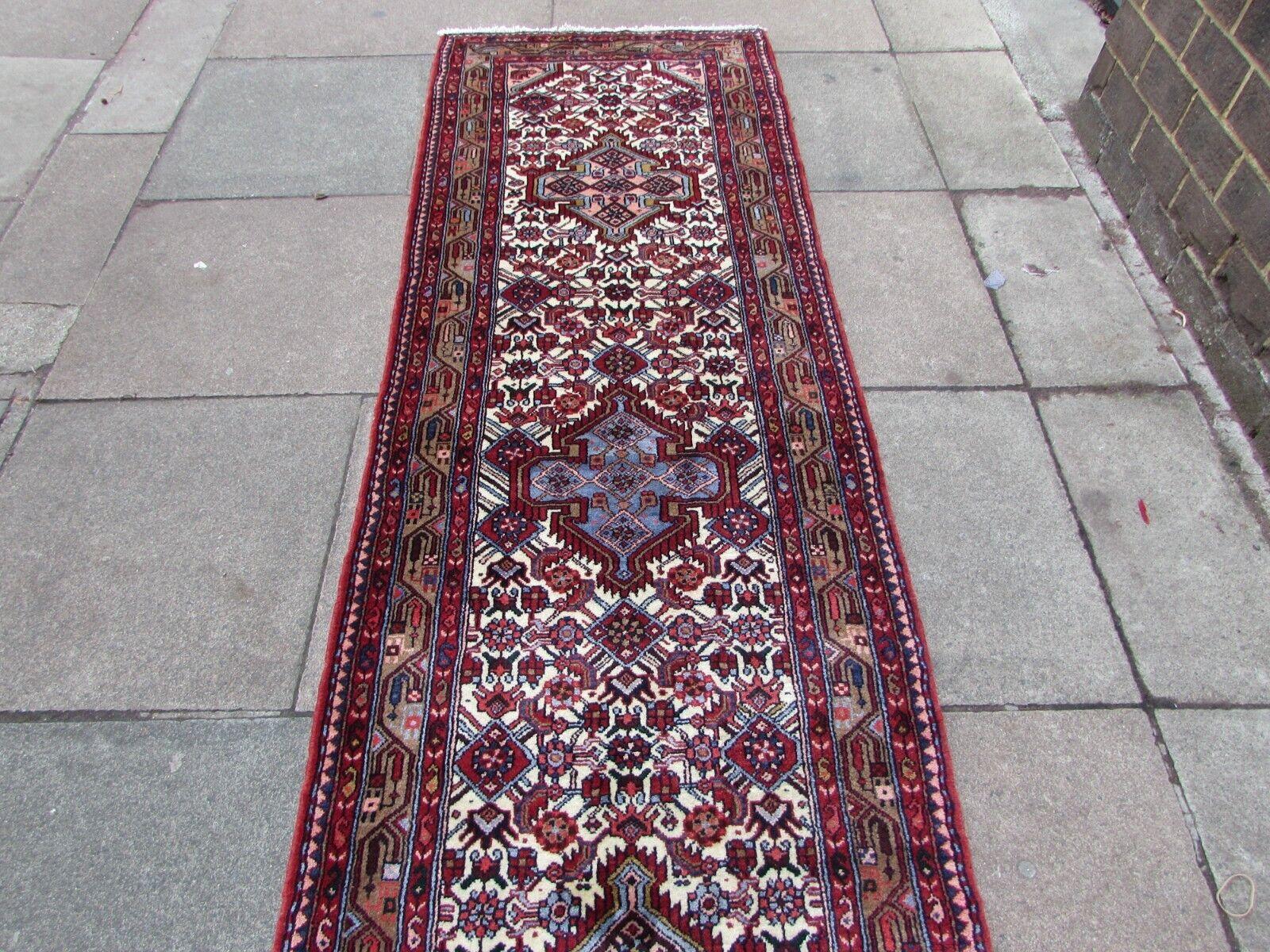 Elevate your living space with this exquisite Handmade Vintage Persian Style Hamadan Runner Rug. It's not just a rug; it's a piece of art that carries with it the history and traditions of Persian craftsmanship.

Key Features:

Traditional Elegance: