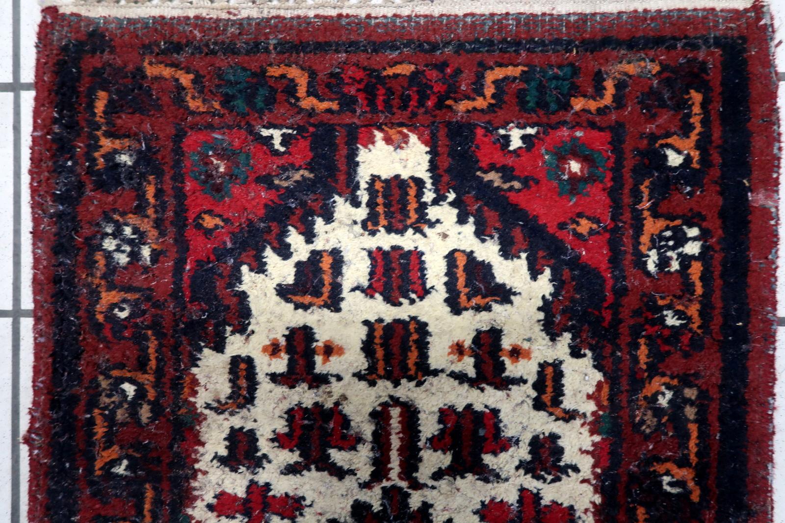 Step into the past with our exquisite Vintage Persian-Style Hamadan Rug, meticulously crafted in the Middle East during the 1970s. This rug carries the allure of history with its original condition, showcasing a touch of age wear that adds to its