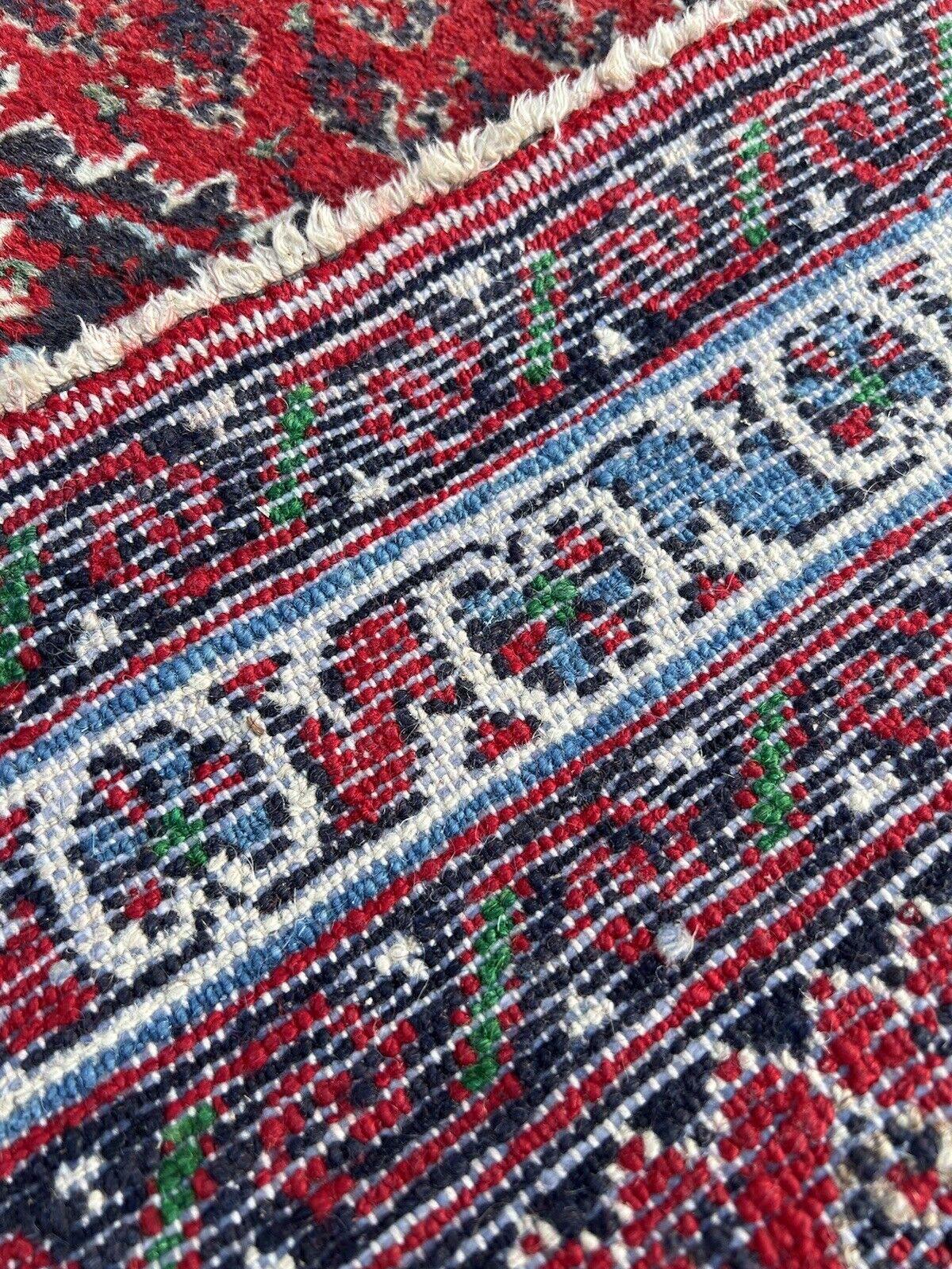 Immerse yourself in the rich heritage of Persian weaving with this Handmade Vintage Persian Style Hamadan Rug. Crafted in the 1970s, this rug measures 2.1’ x 2.9’ (67cm x 89cm) and is a testament to the enduring artistry of Hamadan weavers.

The rug