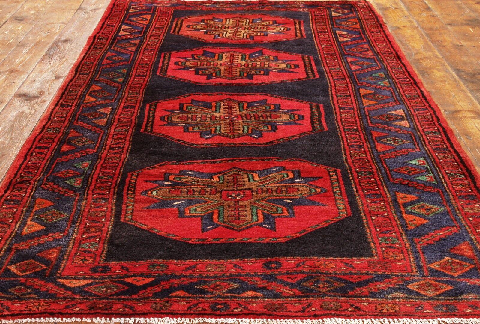 Immerse your space in timeless artistry with our Handmade Vintage Persian Style Hamadan Runner Rug, a masterpiece from the 1970s. Measuring at 4.3' x 8.8', this rug features a captivating medallions design in dark blue and bright red colors,