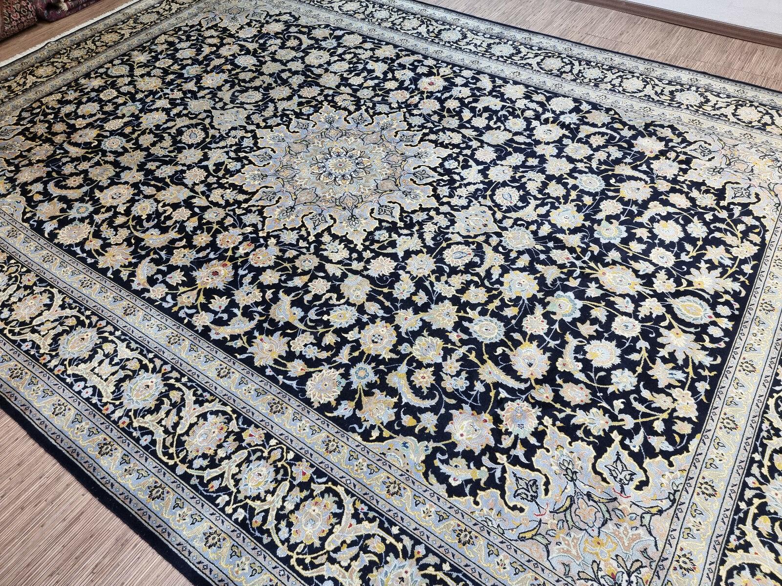 Transform your space with this Handmade Vintage Persian Style Kashan Oversize Rug. This magnificent rug measures at a spacious 10.1’ x 14.4’ (310cm x 440cm), making it ideal for large rooms and areas.

Color Palette: The rug features a dark base