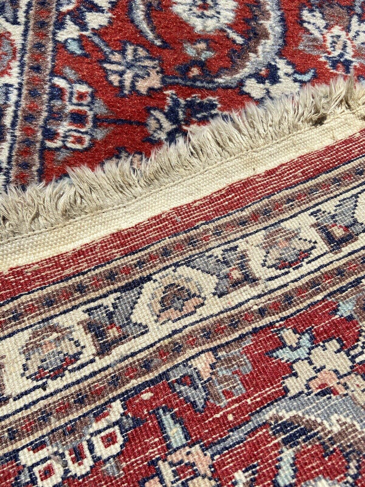 Elevate your space with the classic elegance of our Handmade Vintage Persian Style Kashan Rug. This small runner, measuring 1.5’ x 3.7’, is a genuine artifact from the 1970s, carrying the legacy of Persian rug-making into the modern era.

Material: