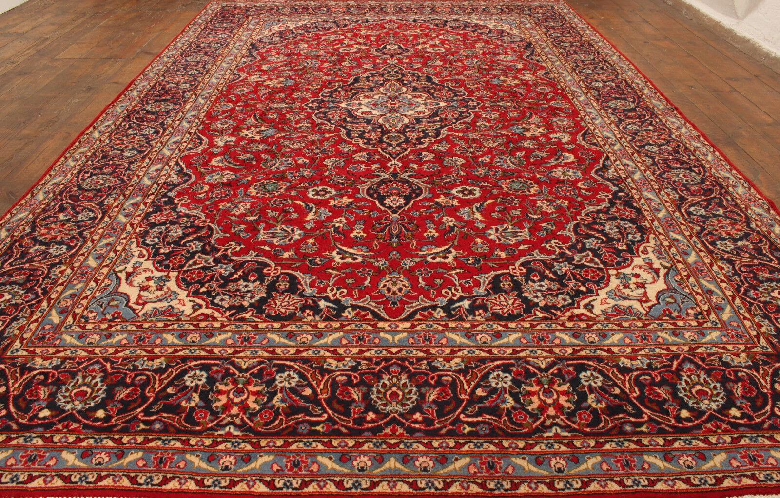 Immerse your home in classic grandeur with our Handmade Vintage Persian Style Kashan Rug, a timeless piece from the 1980s. Measuring at 7.8' x 12.3', this rug features a rich red color and traditional medallion design, adding a touch of elegance to