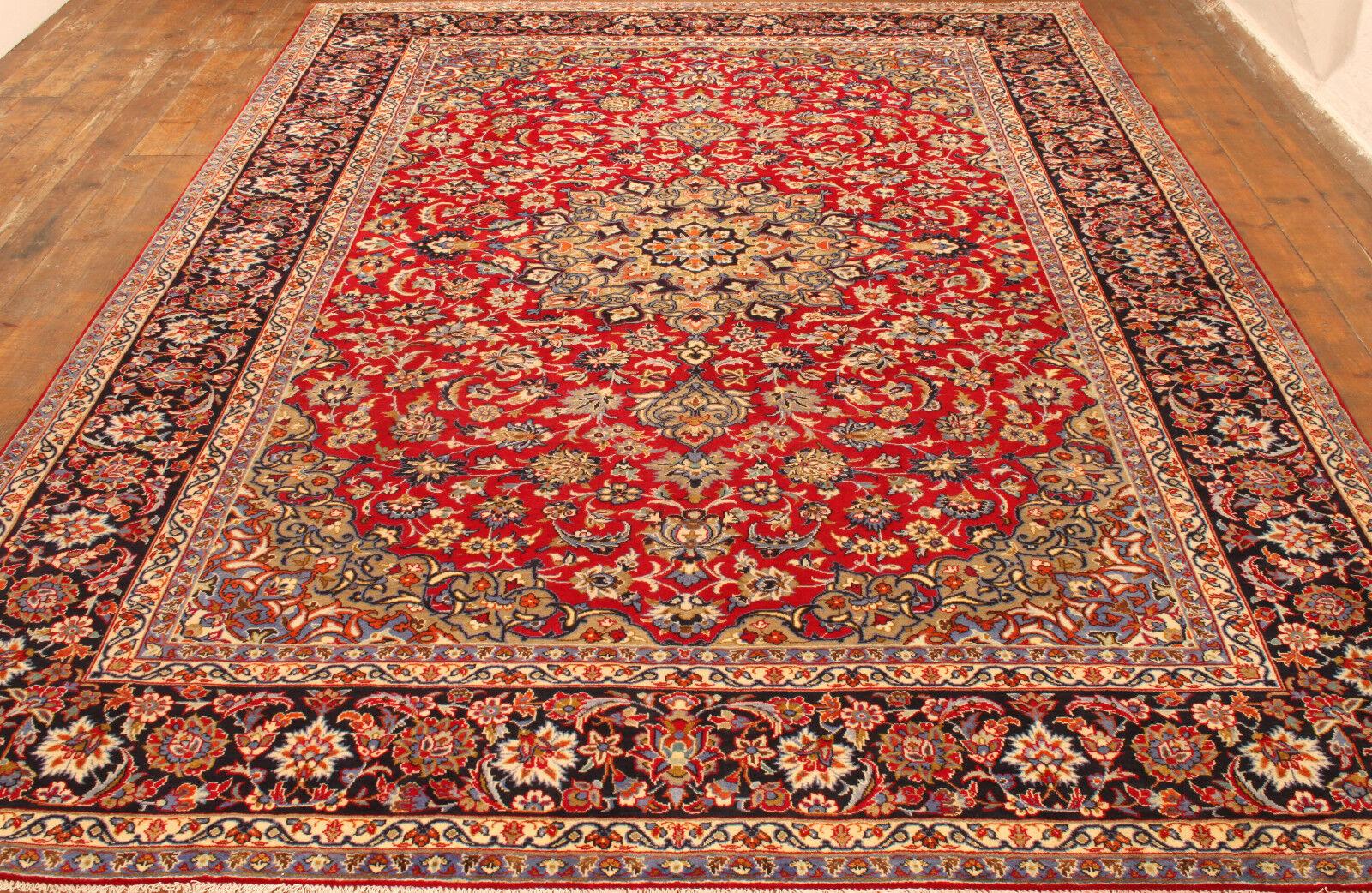Elevate your space with classic grandeur using our Handmade Vintage Persian Style Kashan Rug, a majestic creation from the 1960s. Measuring at an impressive 9.6' x 14.1', this rug showcases a timeless medallion design in rich red and blue shades,