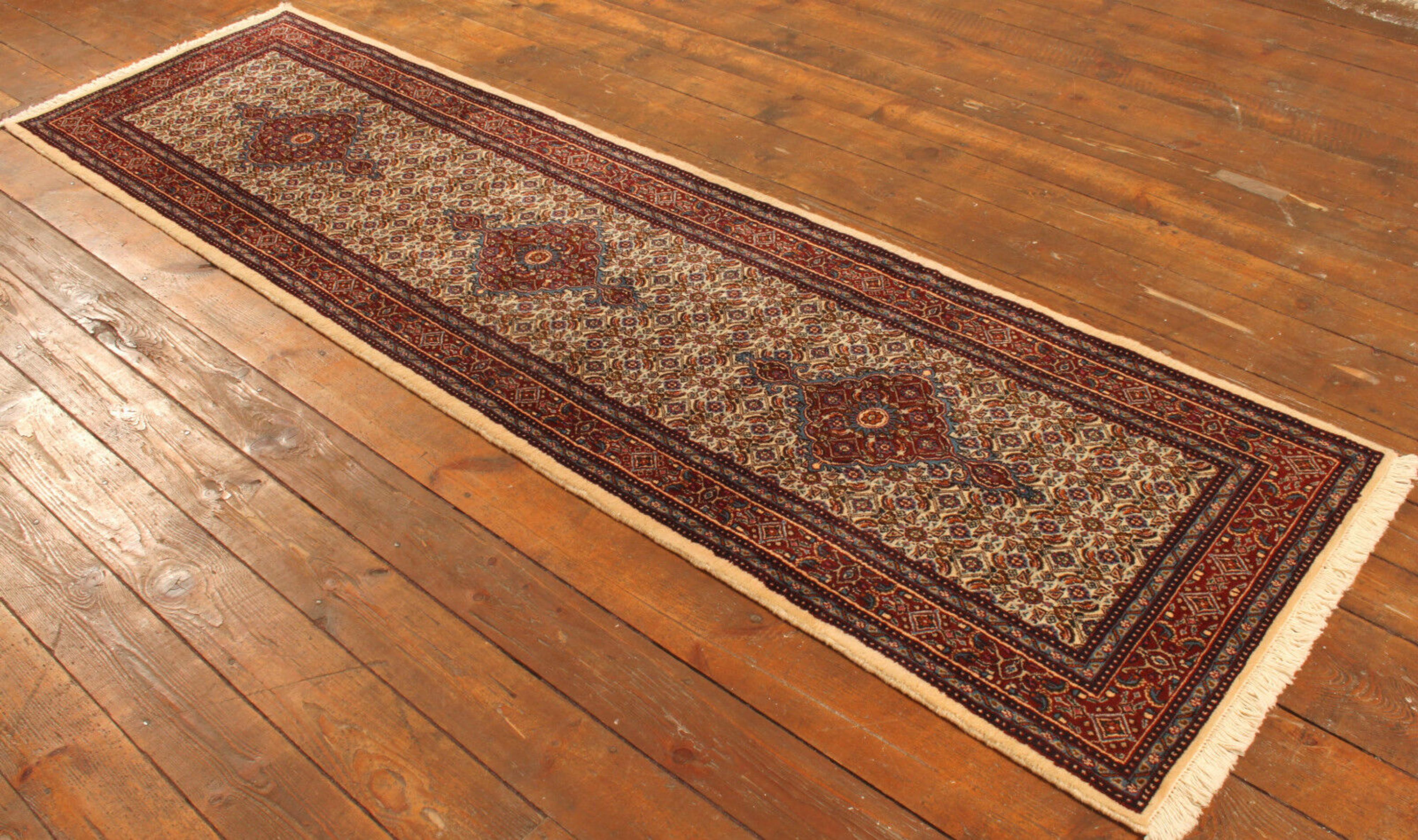 Handmade Vintage Persian Style Moud Runner Rug (2.6’ x 9.6’ / 82cm x 295cm)

Introducing the timeless allure of our Handmade Vintage Persian Style Moud Runner Rug. Originating from the 1980s, this woolen runner rug measures 2.6’ x 9.6’ (82cm x