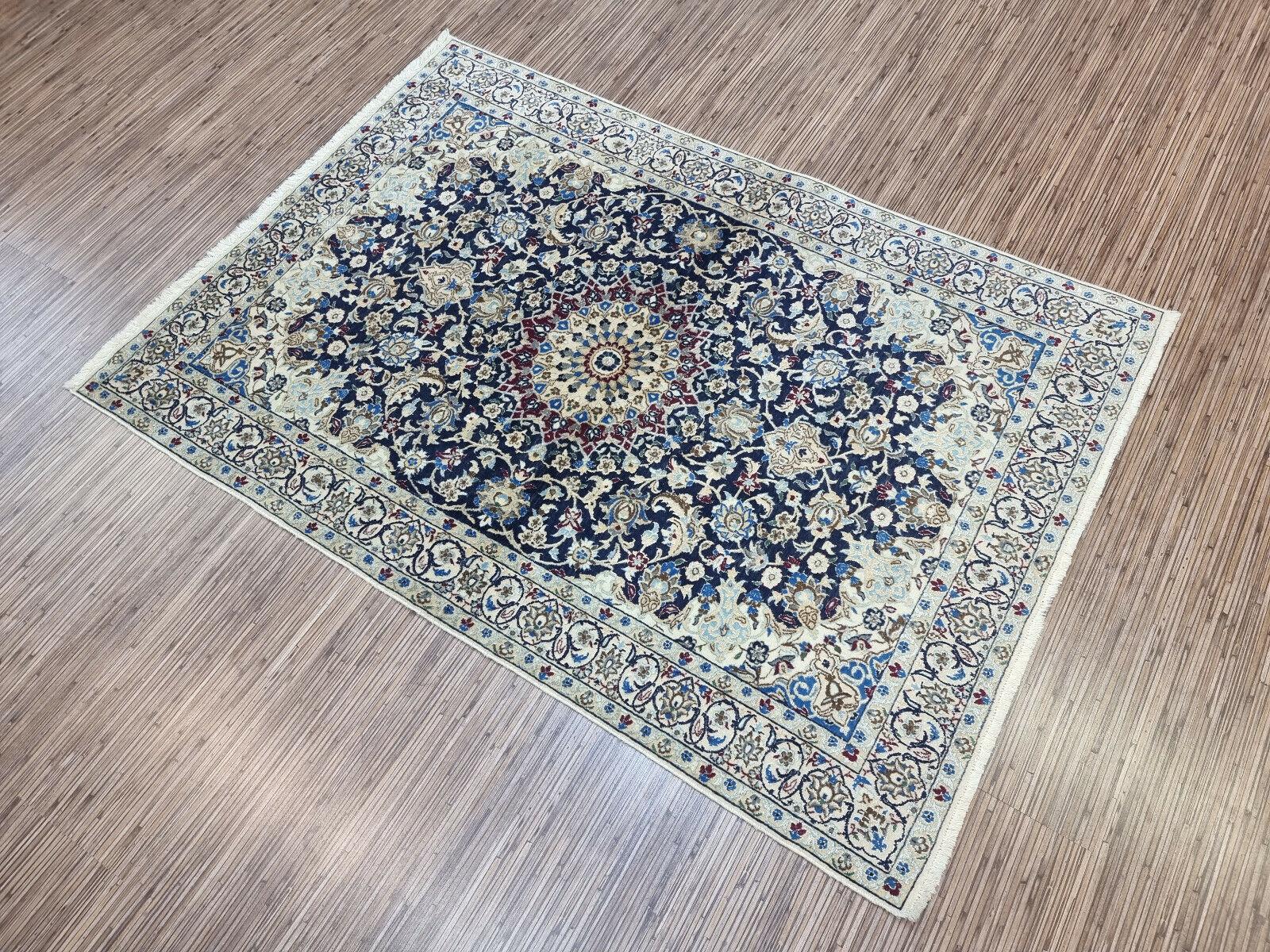 Immerse your living space in the elegance of the past with our Handmade Vintage Persian Style Nain Rug. Crafted meticulously in the 1980s, this exquisite piece measures 3.2’ x 4.6’, offering ample coverage for your floor. The rug is woven from