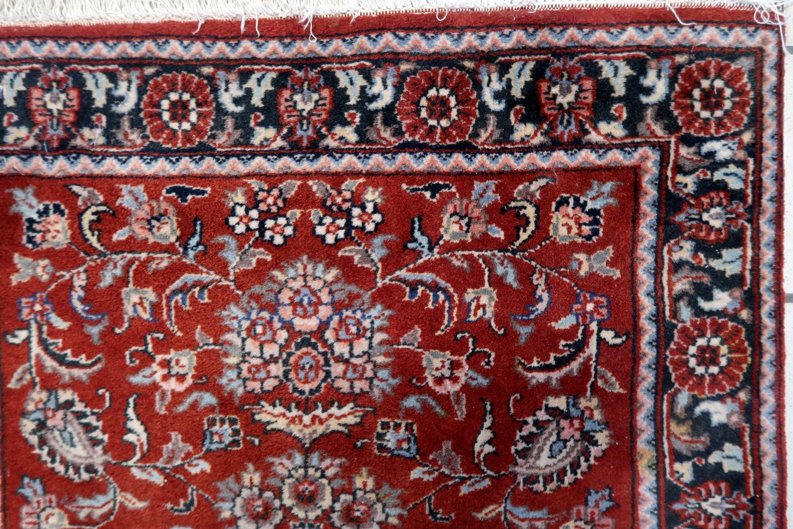 Handmade Vintage Persian Style Sarouk Rug from the 1970s. This exquisite piece, measuring 2.4 feet by 4 feet, carries a sense of reverence and tradition.

Product Description:
Design & Patterns:
The central area of the rug features an elegant