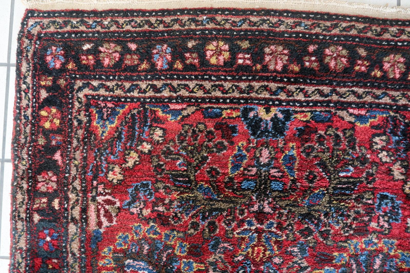 Introducing our exquisite Handmade Vintage Persian Style Sarouk Runner Rug, a captivating piece that harks back to the 1930s and embodies the timeless beauty of traditional Persian craftsmanship. In its original good condition, this rug exudes