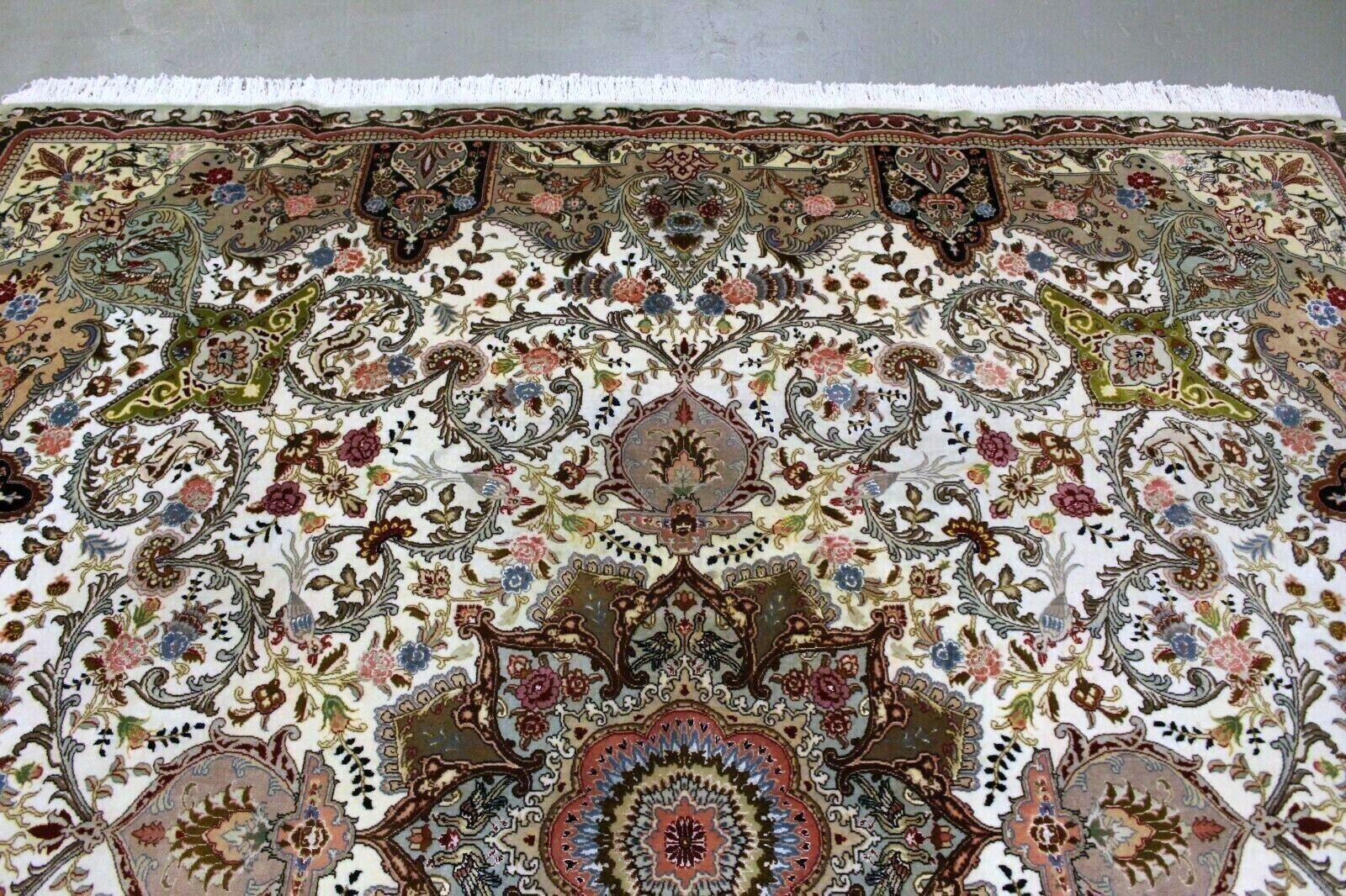 This captivating rug, crafted in the 1970s, seamlessly blends tradition and opulence. Here are the key features that make it a true work of art:

Materials:
50 Raj Tabriz rug. Wool Base: The rug is meticulously woven from high-quality wool, ensuring