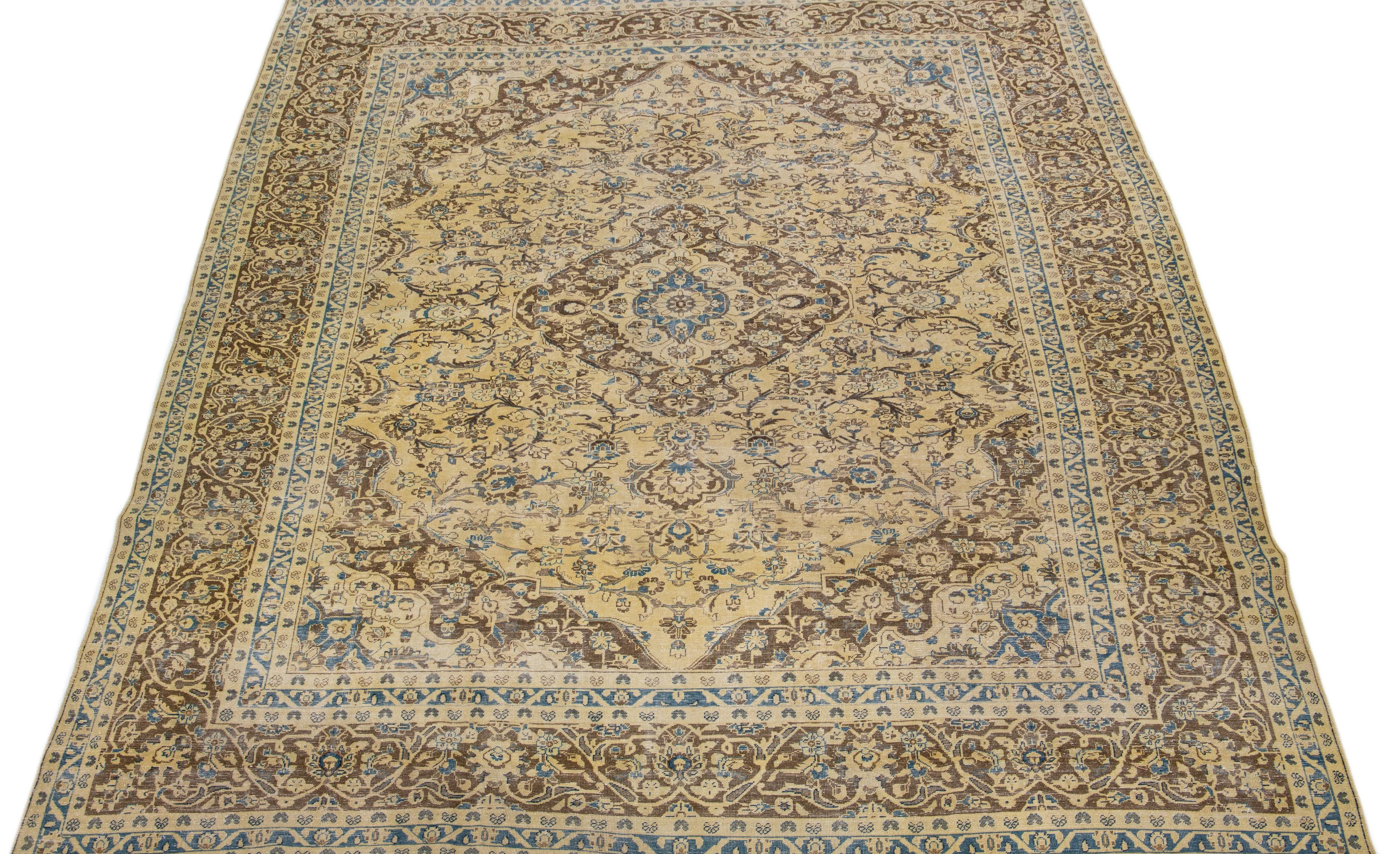 This vintage Tabriz rug boasts a beige color field and features exquisite, hand-knotted wool construction complemented by hints of brown and blue in an all-over medallion floral pattern.

This rug measures: 9'4