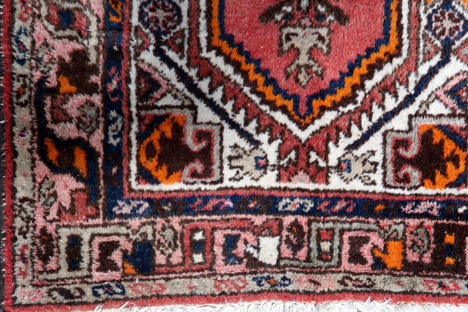 Introducing our Handmade Vintage Persian Hamadan Rug from the 1970s. This exquisite rug showcases a traditional design with a large geometric medallion, making it a captivating centerpiece for any room.

Crafted with care, this rug is in original