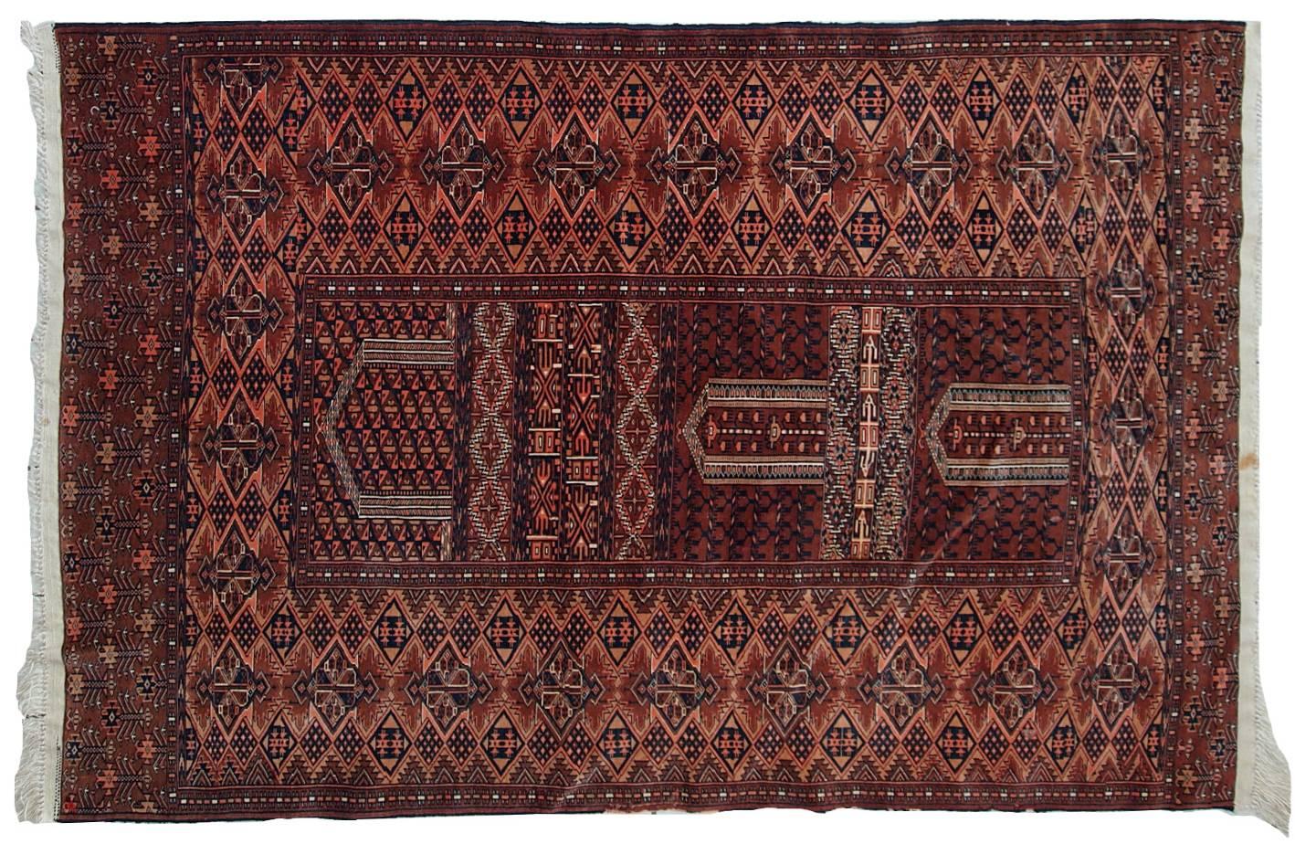 Semi-antique Turkmen Hachli prayer handmade rug in original good condition. The rug is fine weave and very thin. The rug is in burgundy, pink, navy blue and white shades with very busy detailed design.
 