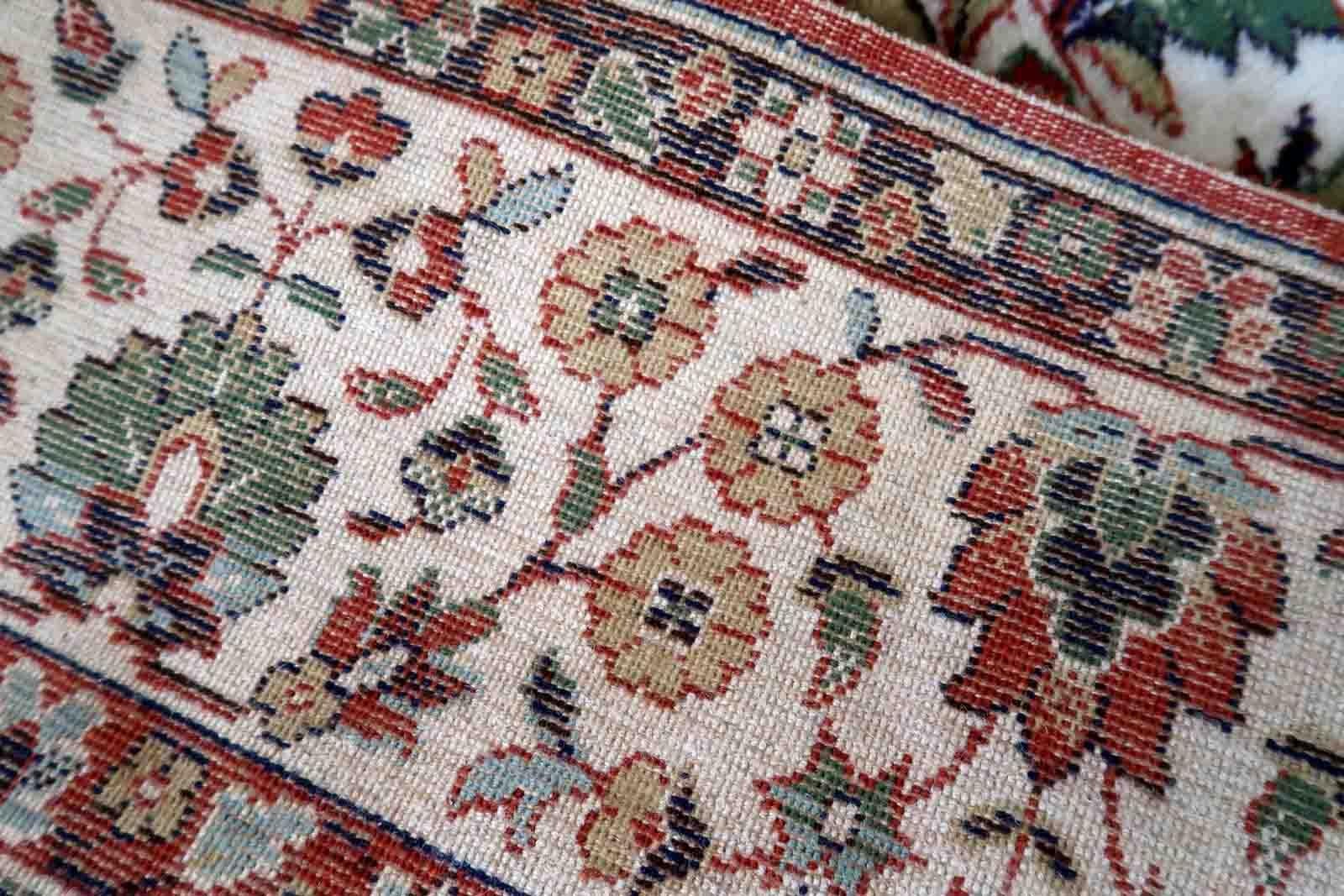 Vintage Indian rug with Qum garden design. This rug is from the end of 20th century in original good condition.