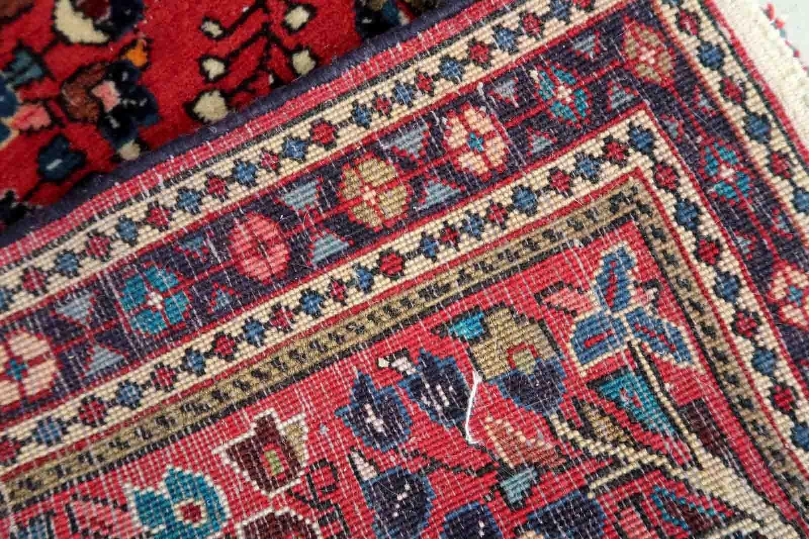 Handmade vintage Sarouk rug in traditional design. The rug is in red color. The rug is from the end of 20th century in original good condition.

-condition: original good,

-circa: 1970s,

-size: 2.1' x 4.2' (66cm x 130cm),

-material: