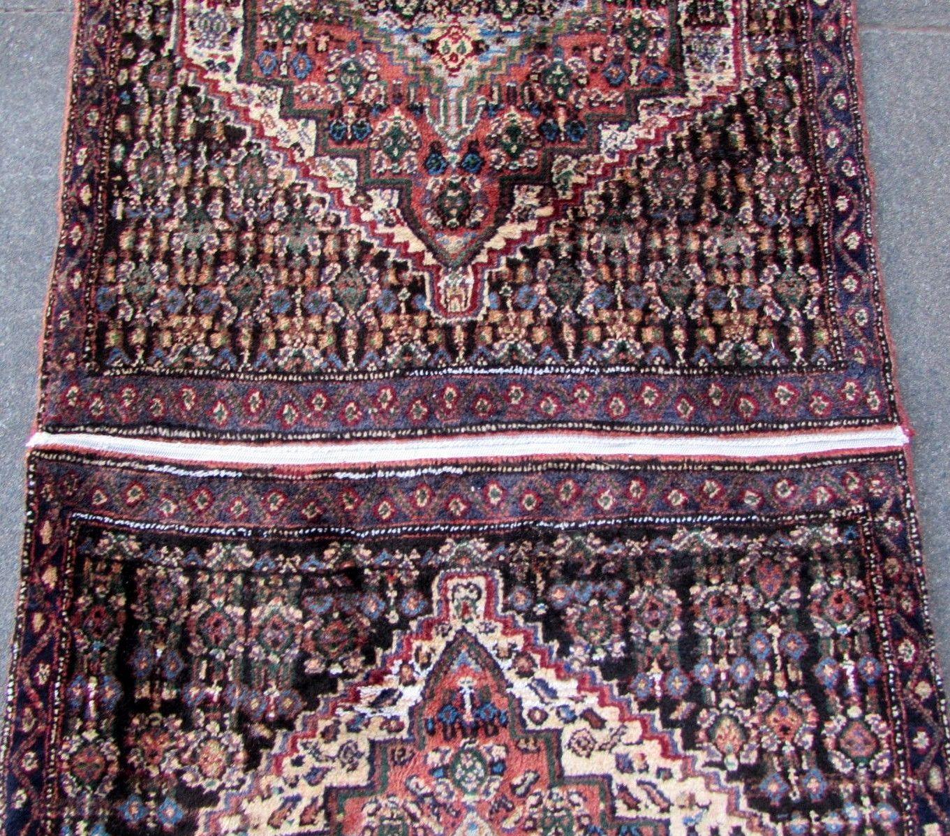 Handmade vintage Senneh runner made out of two smaller rugs. The rug is in original good condition, it is from the mid-20th century.

- Condition: original good,

- circa 1950s,

- Size: 2.6' x 6.5' (76cm x 192cm),

- Material: wool,

-