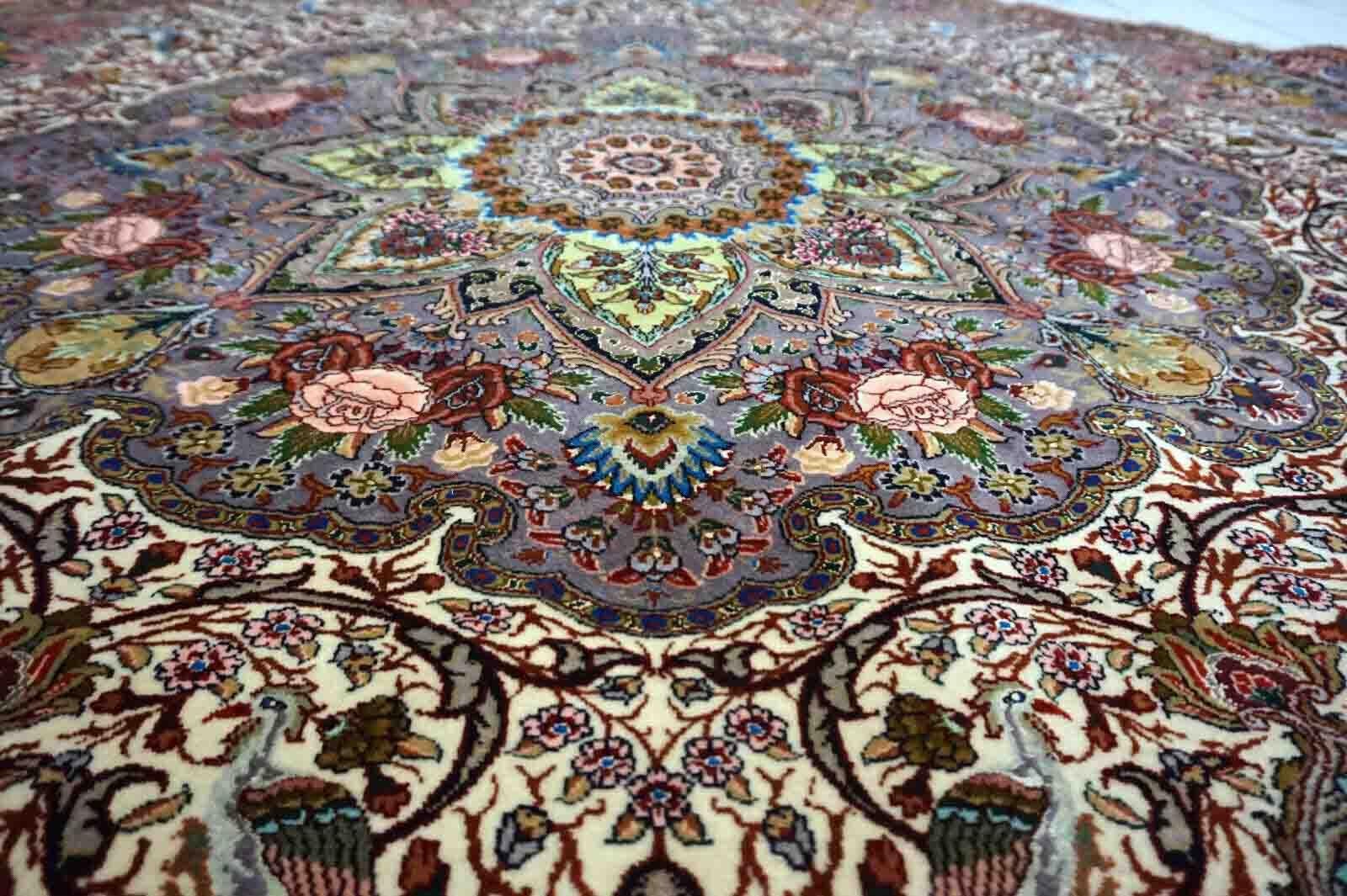 Introducing a stunning vintage Persian Tabriz rug from the 1970s! This exquisite rug features a round shape with a diameter of 6.5 feet (200cm), making it a perfect centerpiece for any room. The rug is made of high-quality wool and silk, which adds