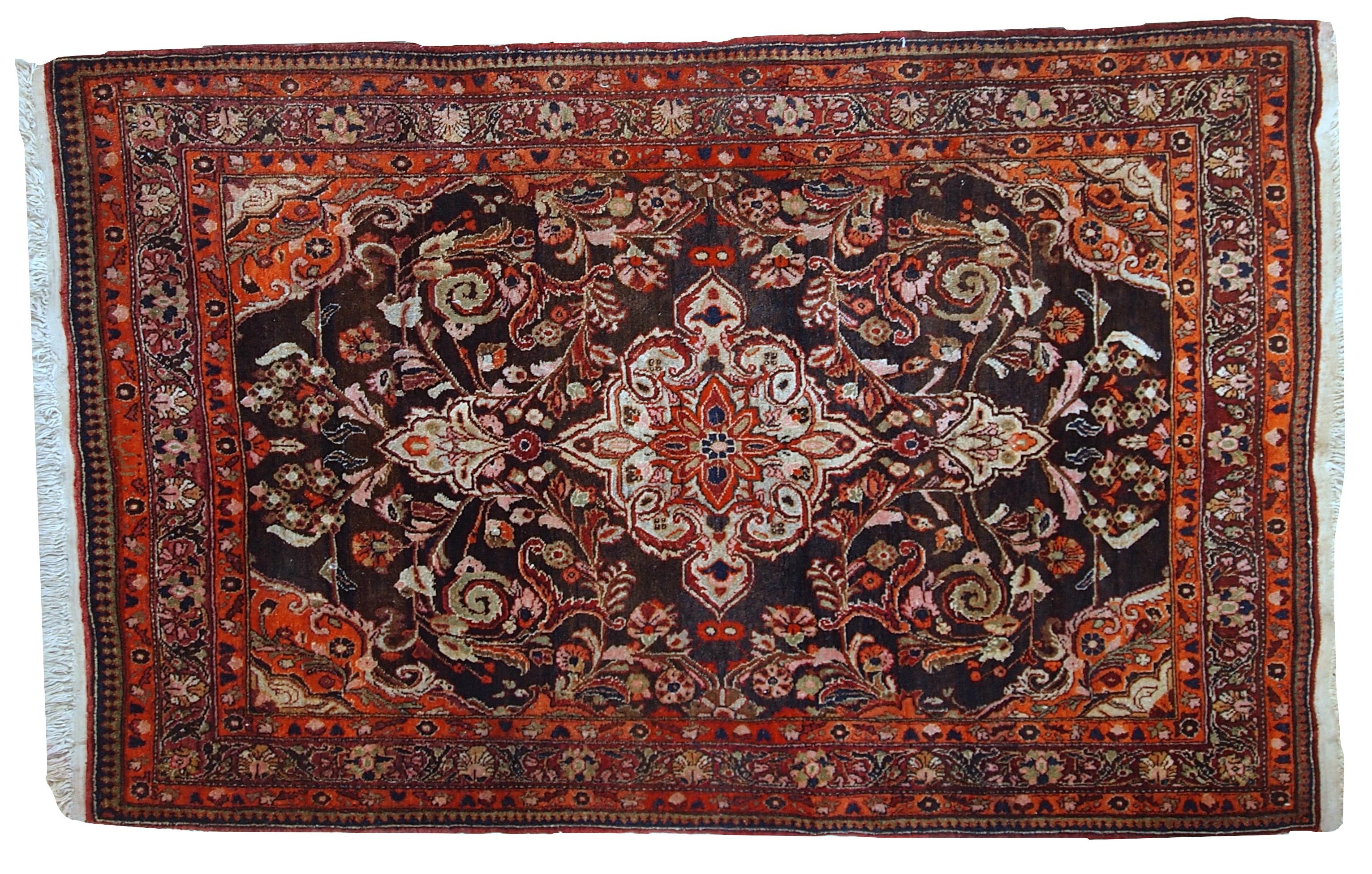 Vintage Tabriz style rug in original good condition. It is in chocolate brown and orange wool with some olive and pink shades.