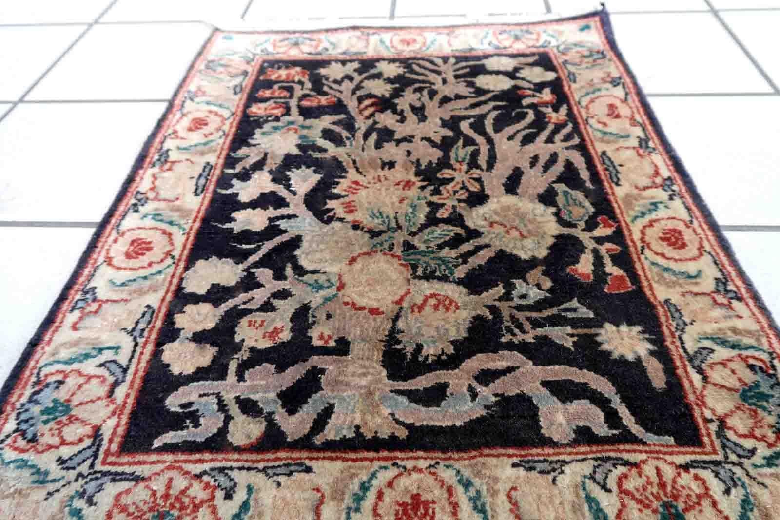 Handmade vintage Tabriz rug in black color and garden design. The rug is from the end of 20th century in original good condition.

-condition: original good,

-circa: 1970s,

-size: 1.5' x 2' (48cm x 64cm),

-material: wool,

-country of