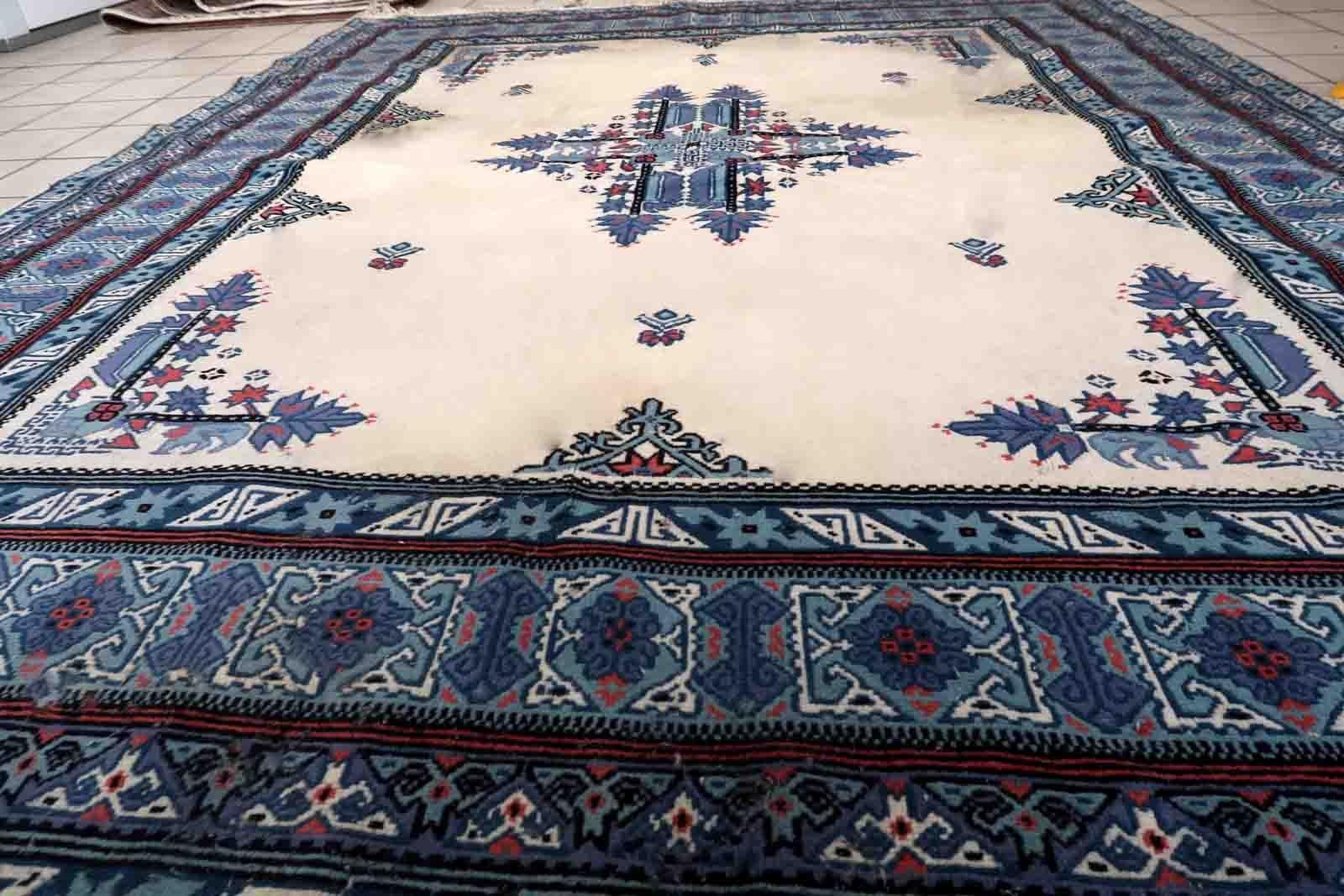 Handmade vintage Tunisian Berber rug in unusual white and blue colors. The rug is from the end of 20th century in original condition, it has some age discolorations.

-condition: original, age discolorations,

-circa: 1970s,

-size: 6.5' x