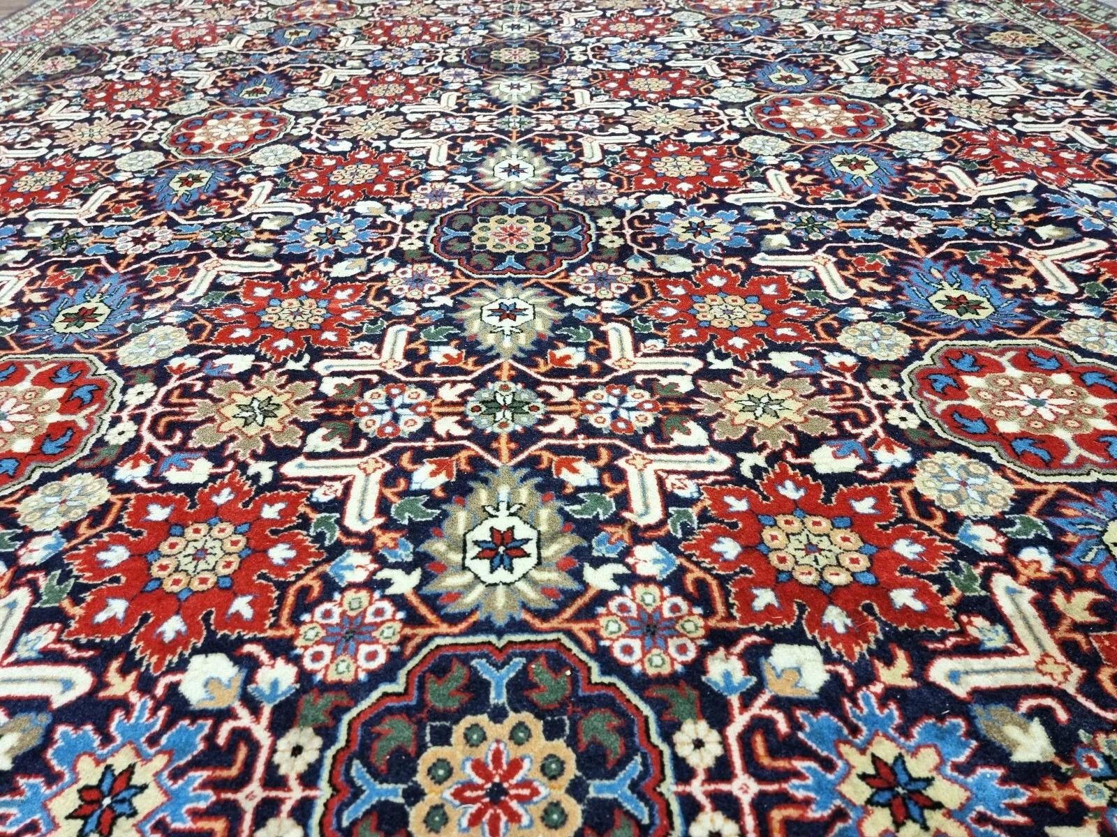 This stunning vintage Turkish Hereke rug, hand-knotted in the 1980s, exemplifies the rich tradition of Turkish craftsmanship. Woven with high-quality wool on a sturdy cotton foundation, it features intricate oriental patterns in a beautiful blue