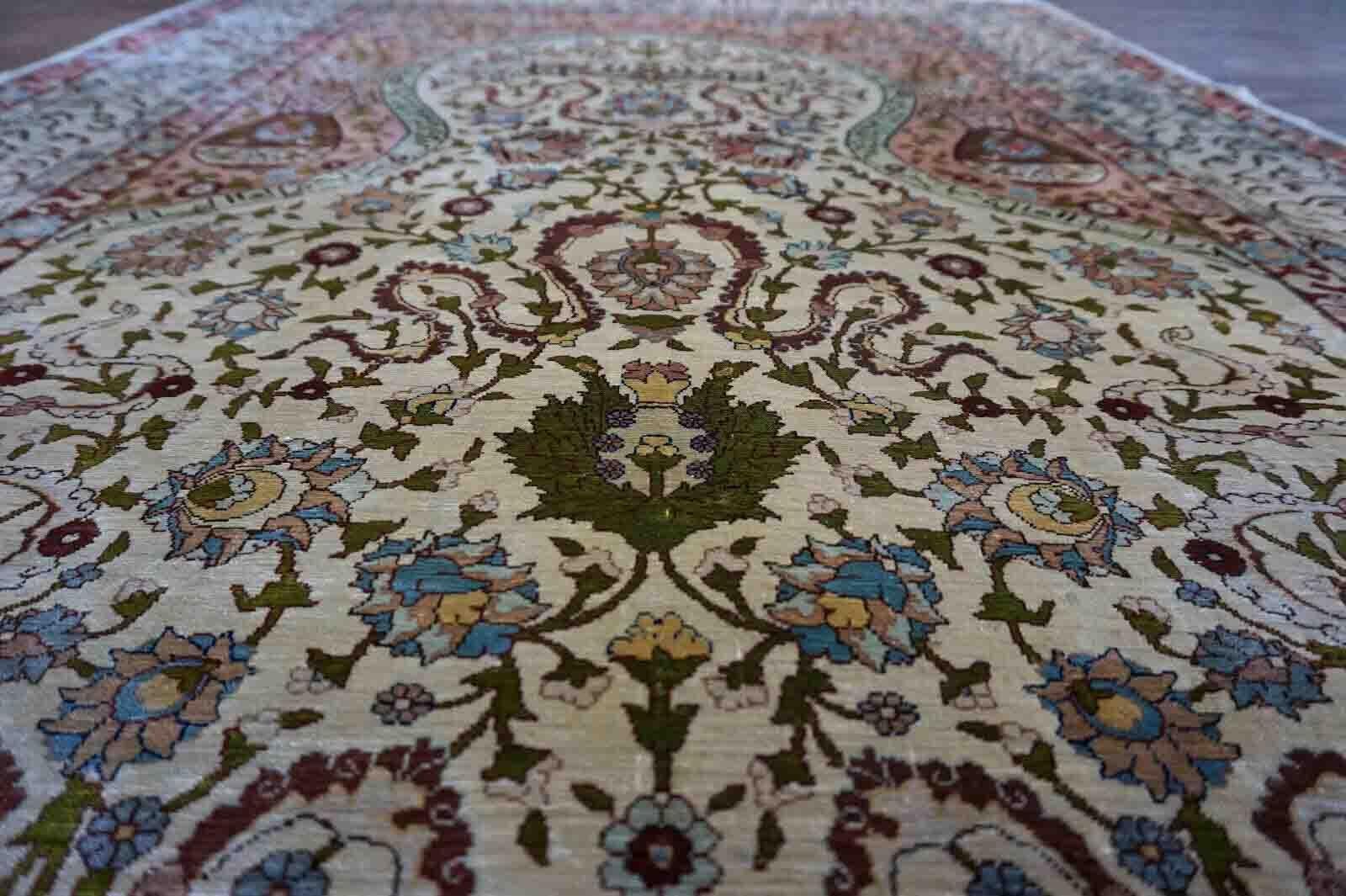 Handmade vintage Turkish Hereke rug made in natural silk and prayer design. The rug is from the middle of 20th century in original good condition.

-Condition: original good,

-Circa: 1950s,

-Size: 3.3' x 5.1' (103cm x 158cm),

-Material: