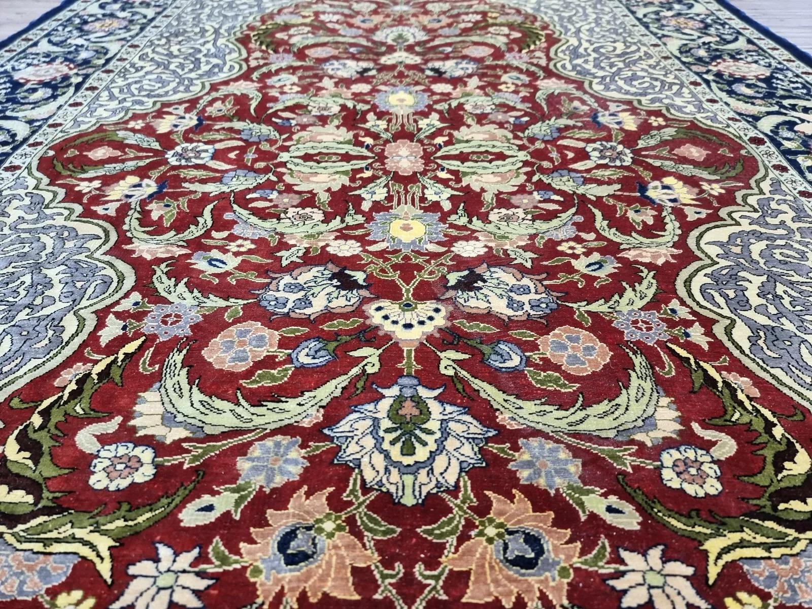 This stunning Turkish Hereke rug, hand-knotted from 100% pure silk, represents the epitome of fine craftsmanship and luxurious design. Made in the 1980s, this exquisite piece has been meticulously preserved as a wall-hanging, ensuring its