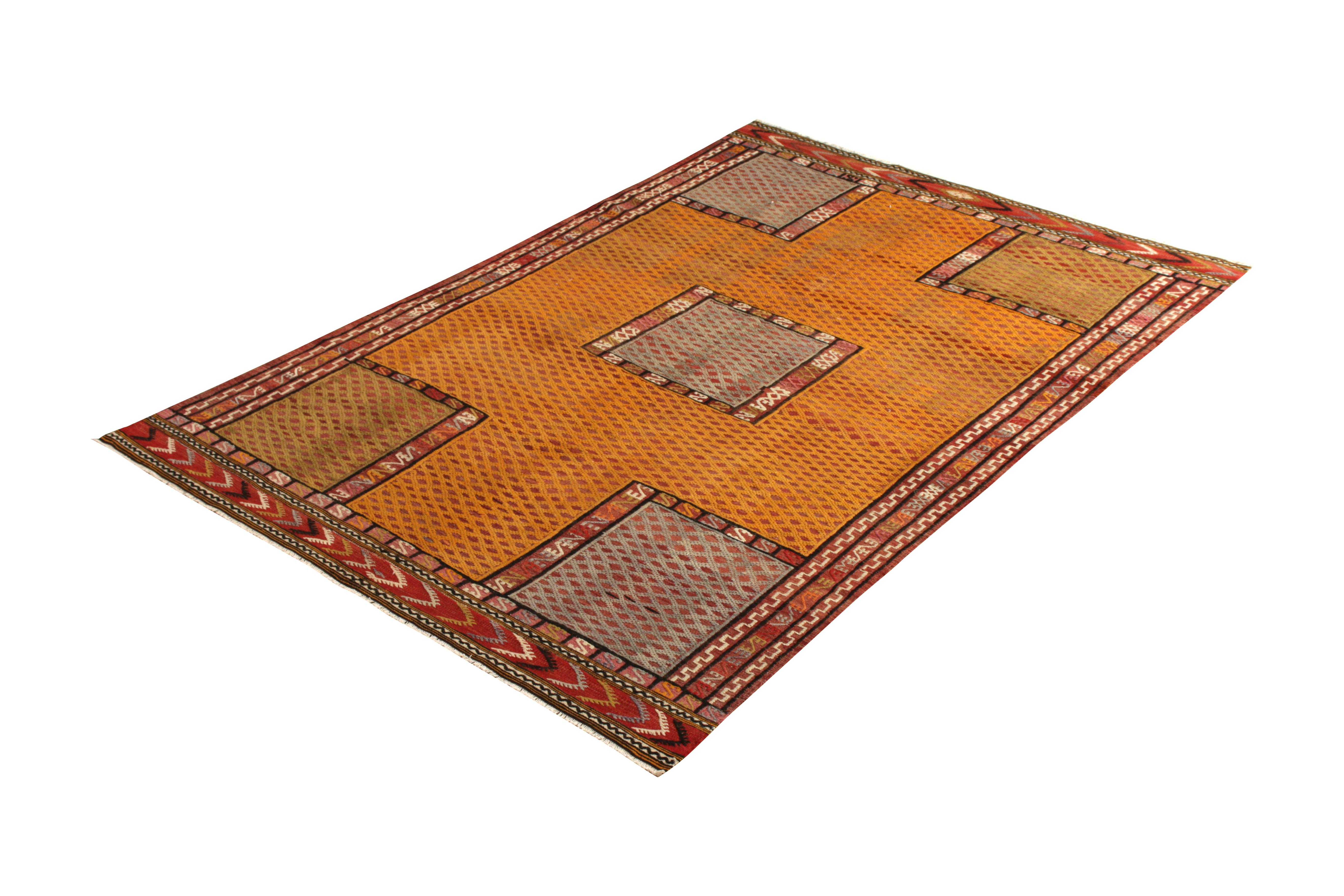 Handwoven in wool originating from Turkey circa 1950-1960, this 6’4 x 9’5 rug is a vintage midcentury Kilim rug embellished with a textural flat weaving and embroidery style—offering a natural tactile allure and depth of movement in the play of gold