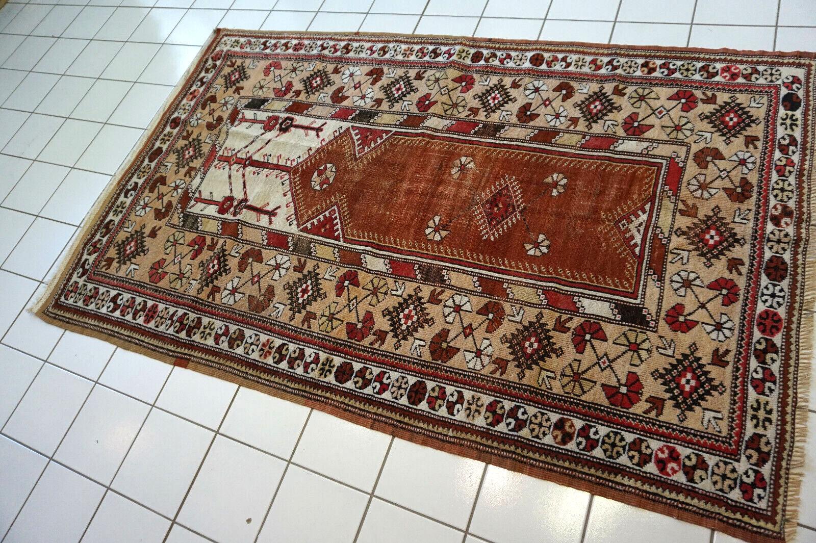Design and Patterns:

This rug showcases a rich, intricate design typical of traditional Turkish Melas rugs.
Geometric patterns and symbols adorn the surface, reflecting the cultural heritage of Anatolia.
The warm, earthy primary color sets the