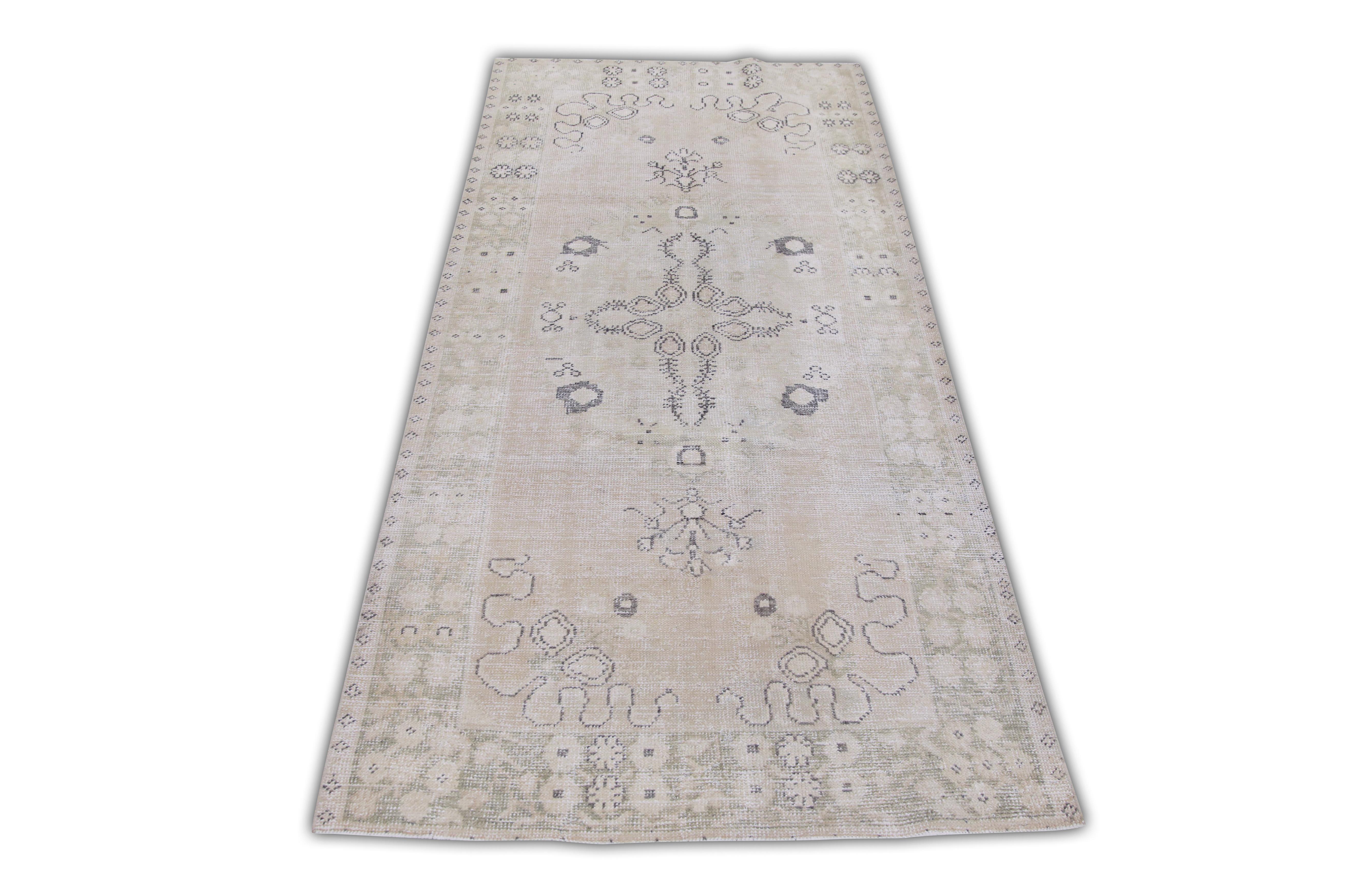 Introducing a one-of-a-kind vintage Turkish hand-knotted wool rug, carefully crafted by skilled artisans using traditional techniques passed down through generations. This exquisite rug boasts a stunning array of natural dyes, resulting in a rich