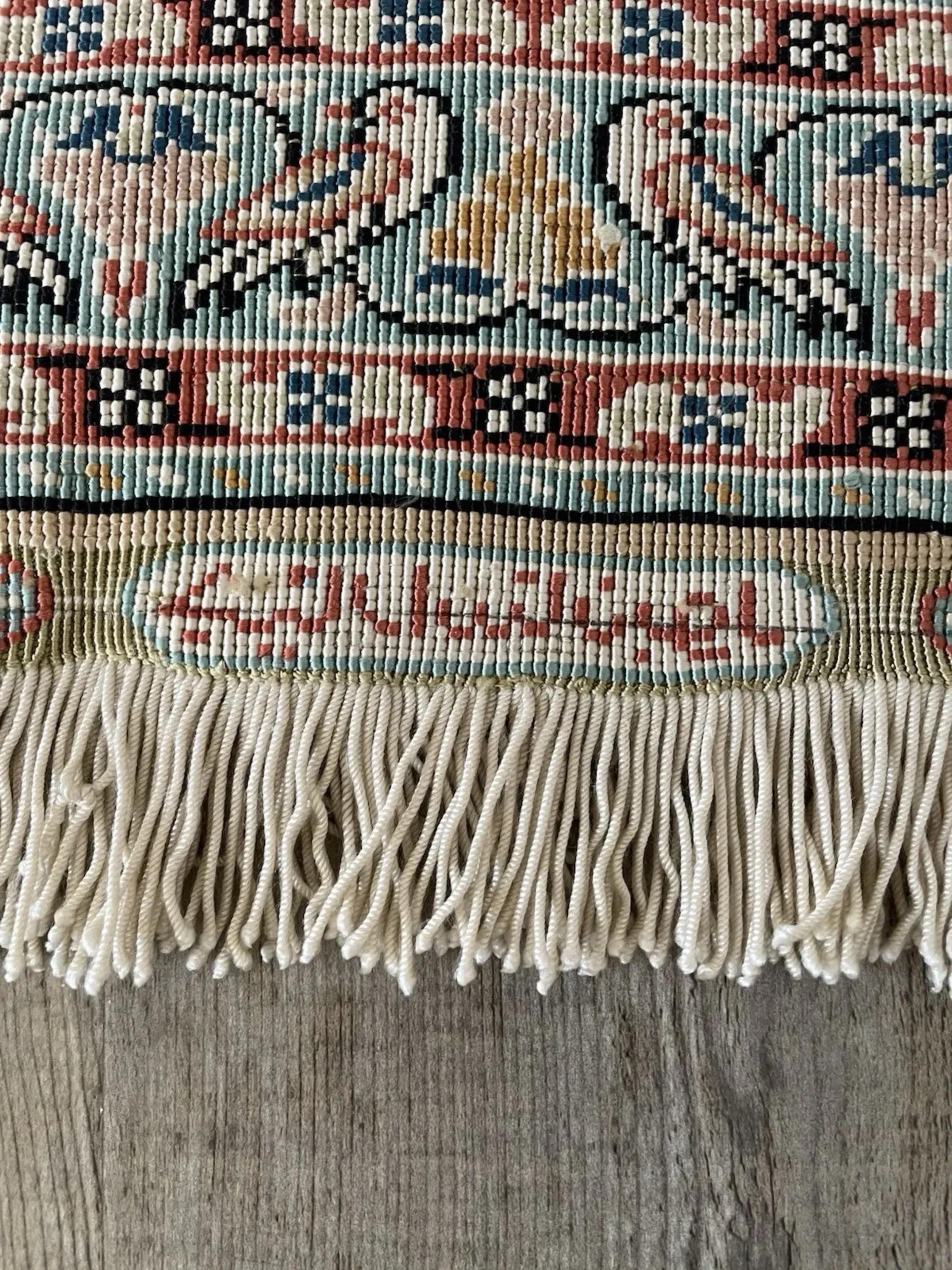 An exceptionally fine and collectible piece, this Vintage Turkish Hereke Silk Rug is a miniature textile masterpiece. Hand-knotted entirely in silk, these small Hereke pieces are famous for their incredibly high knot density and luminous quality,